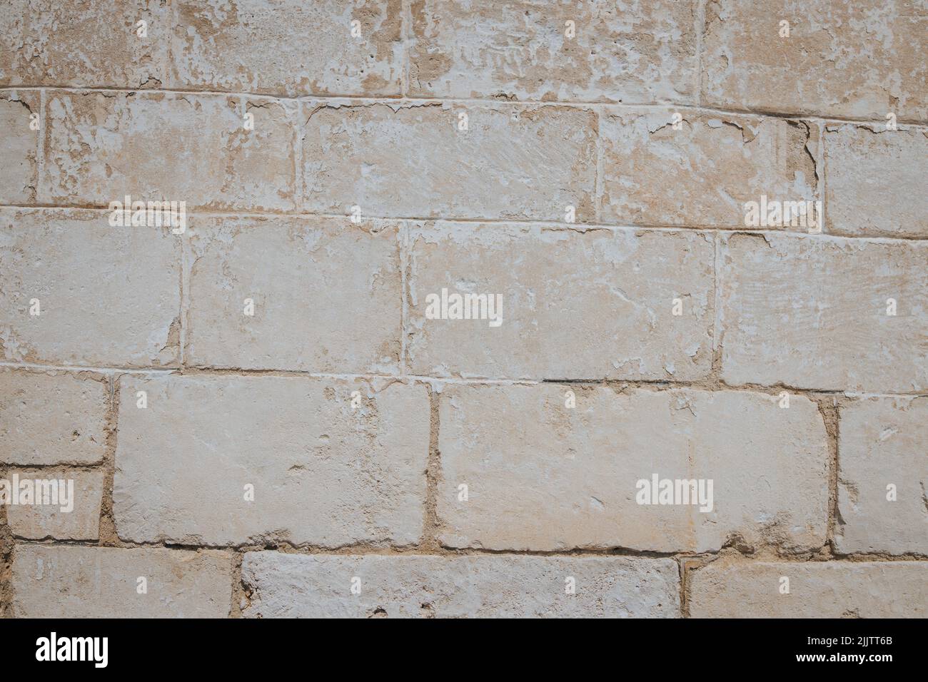 A closeup of a beige old rough weathered wall Stock Photo