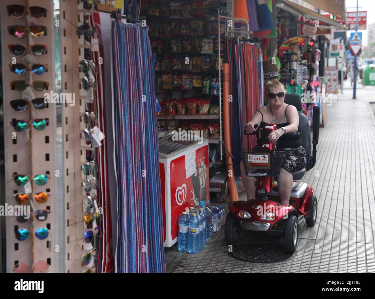 Benidorm, Spain. 27th July, 2022. Holidaymakers riding mobility