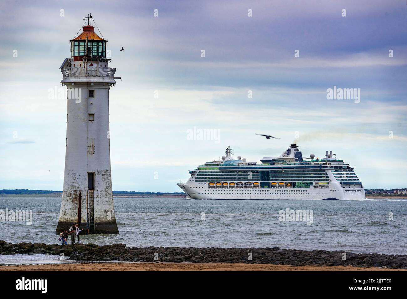 Jewel of the Seas ithe Radiance-class cruise ship operated by Royal Caribbean seen passing Perch Rock lighthoouse on the river Mersey. Stock Photo