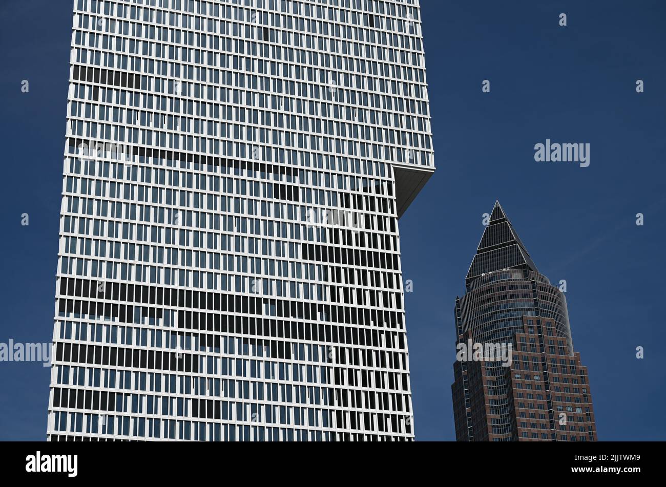 28 July 2022, Hessen, Frankfurt/Main: The 'One' high-rise (l) by Meurer Architekten rises up in the Europaviertel next to the Messeturm. One' is one of the two new high-rise buildings in Frankfurt nominated for the International Highrise Award. A total of 34 high-rise buildings on four continents are in the running. (to dpa 'Two Frankfurt buildings nominated for high-rise award') Photo: Arne Dedert/dpa Stock Photo