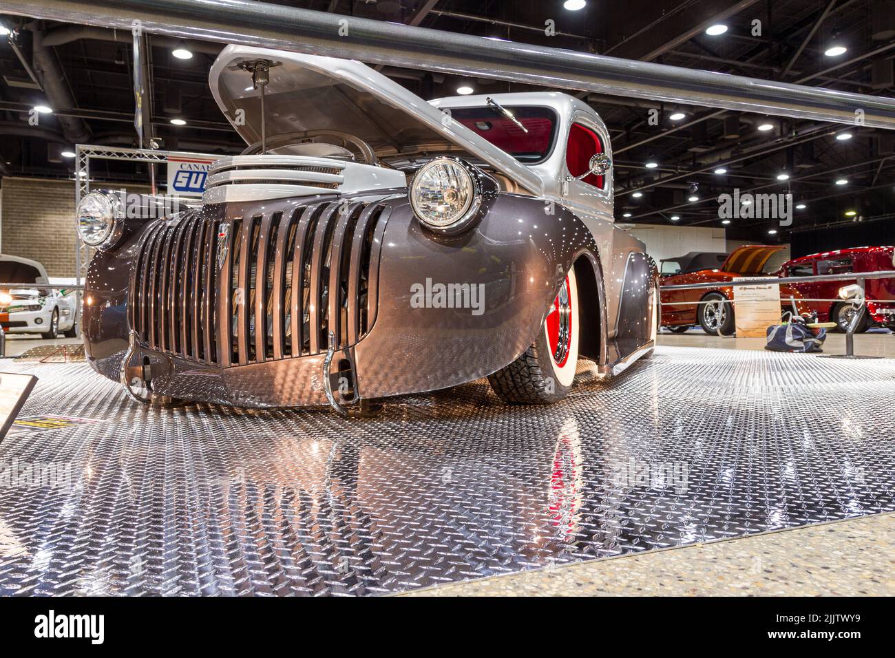 A vintage gray car on display at the World Of Wheels Exhibit in