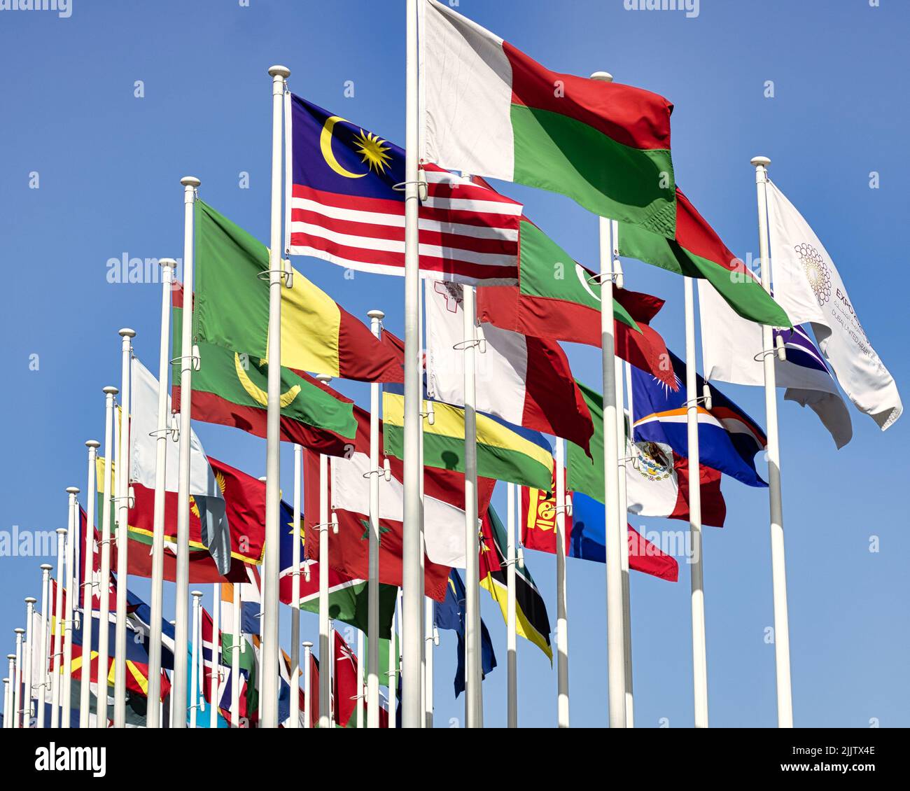 The waving flags of the different countries on the poles during the