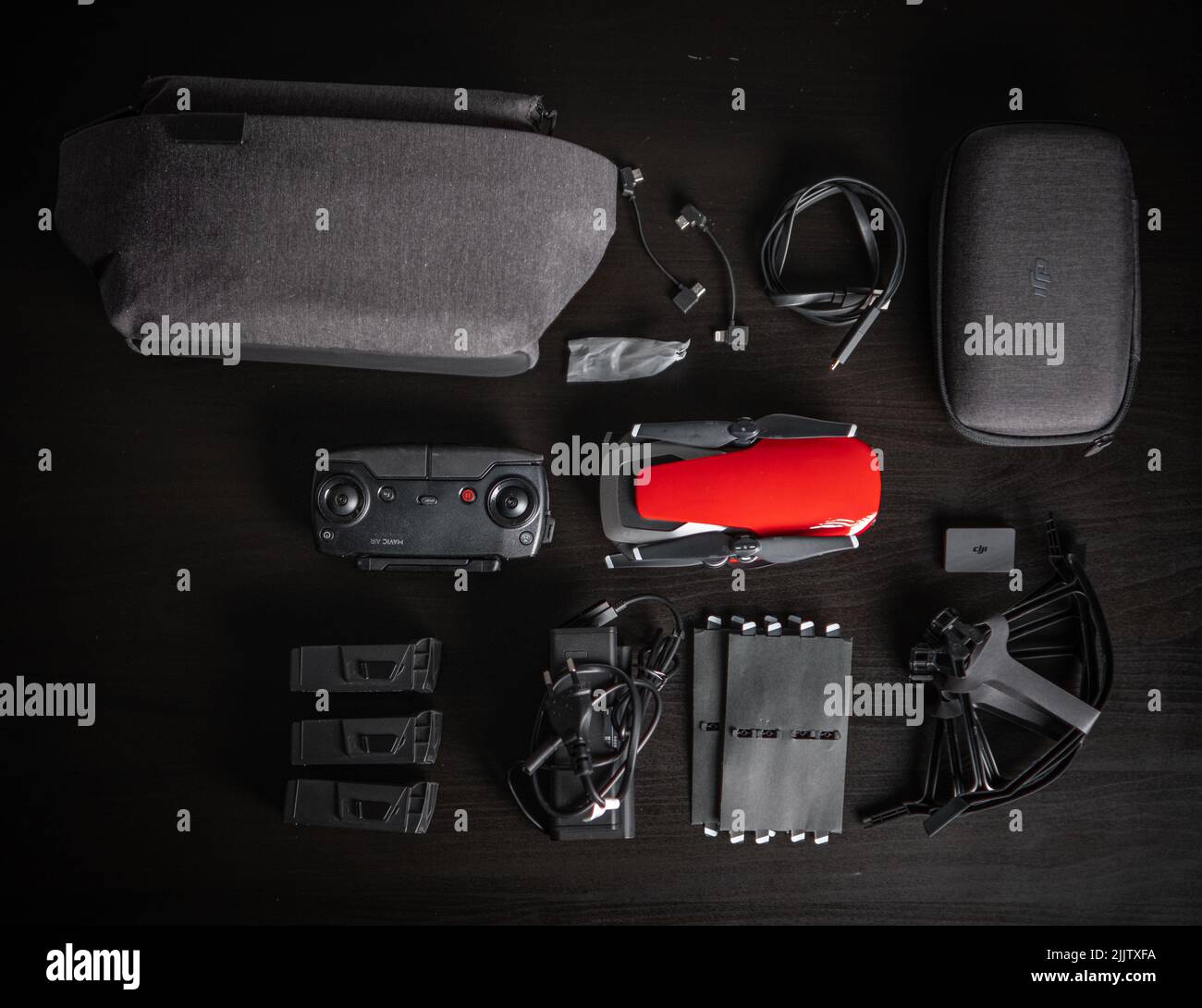 A top view of a red drone DJI Mavic Air Fly More Combo, charger