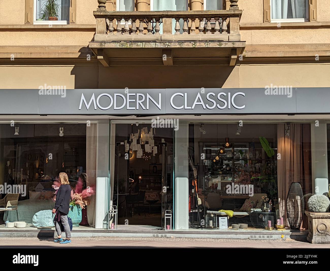 A shop window of a modern furniture store Modern Classic with people