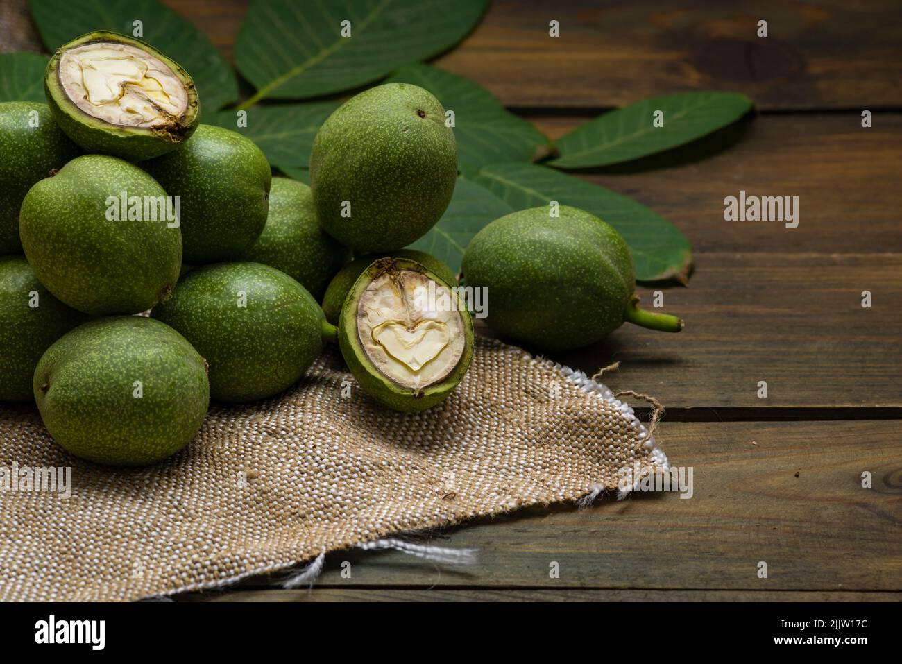 green walnut kernels leaves wooden table oil nuts unripe husks healthy