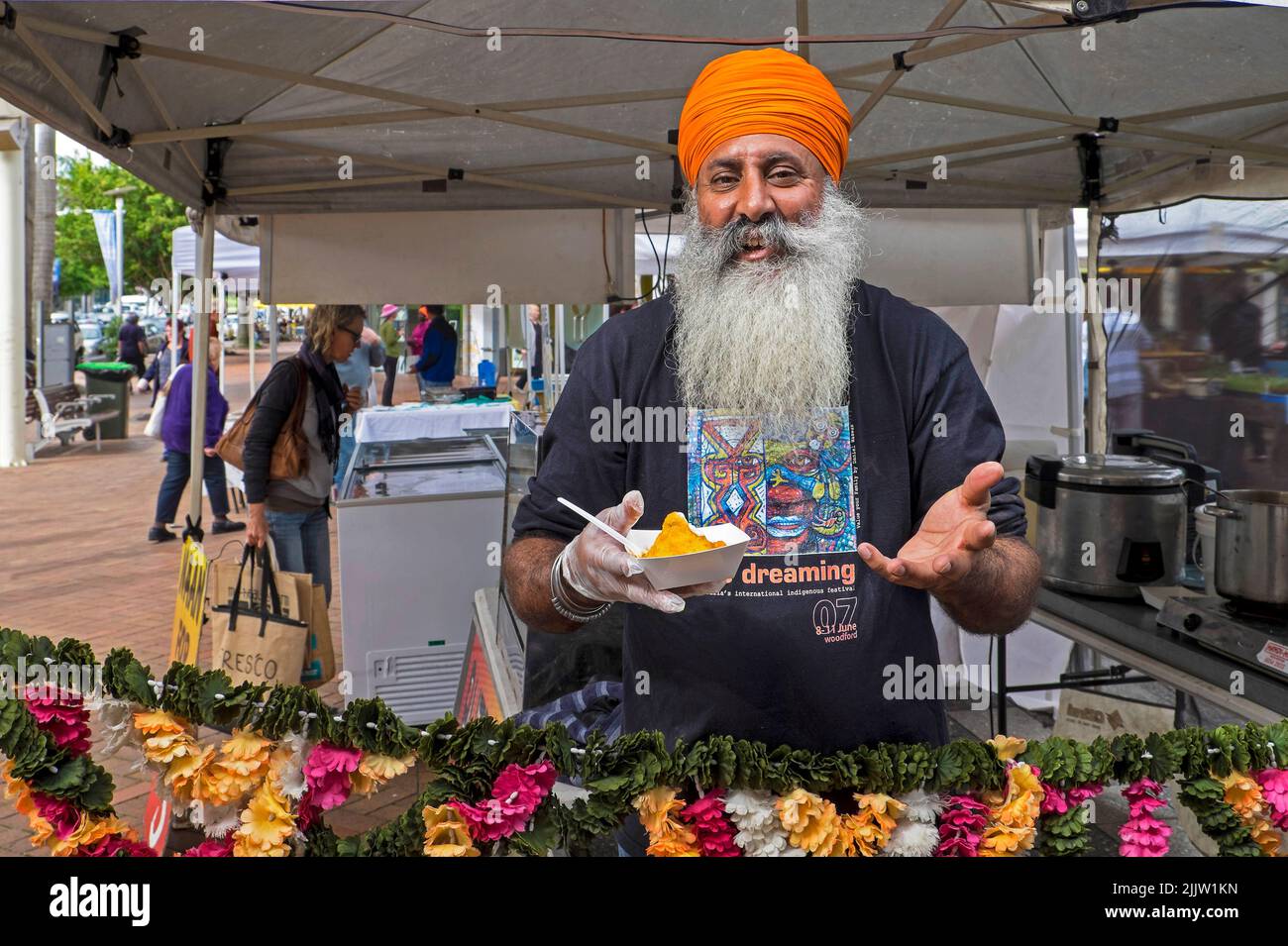 John Arkin, Sikh Businessman and Town Councillor, Coffs Harbour working on his samosa stall at a market in central Coffs Harbour. John, who is active politically, is a councillor on the Coffs Harbour Council and narrowly missed being elected mayor at the last elections. Stock Photo