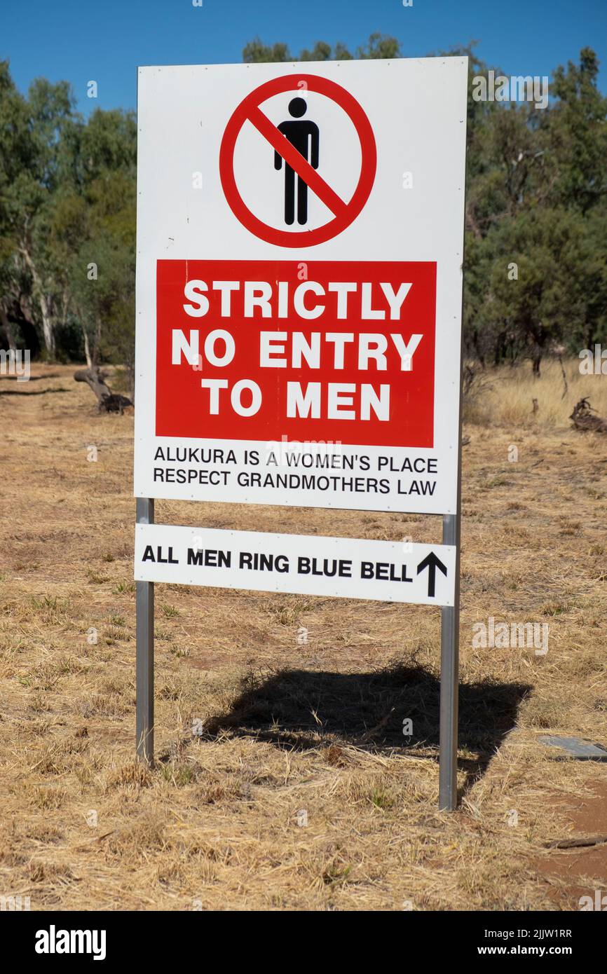 Sign on Indigenous aboriginal land near Alice Springs notifying that entry by men to an area used for women's ceremonial activity is restricted Stock Photo