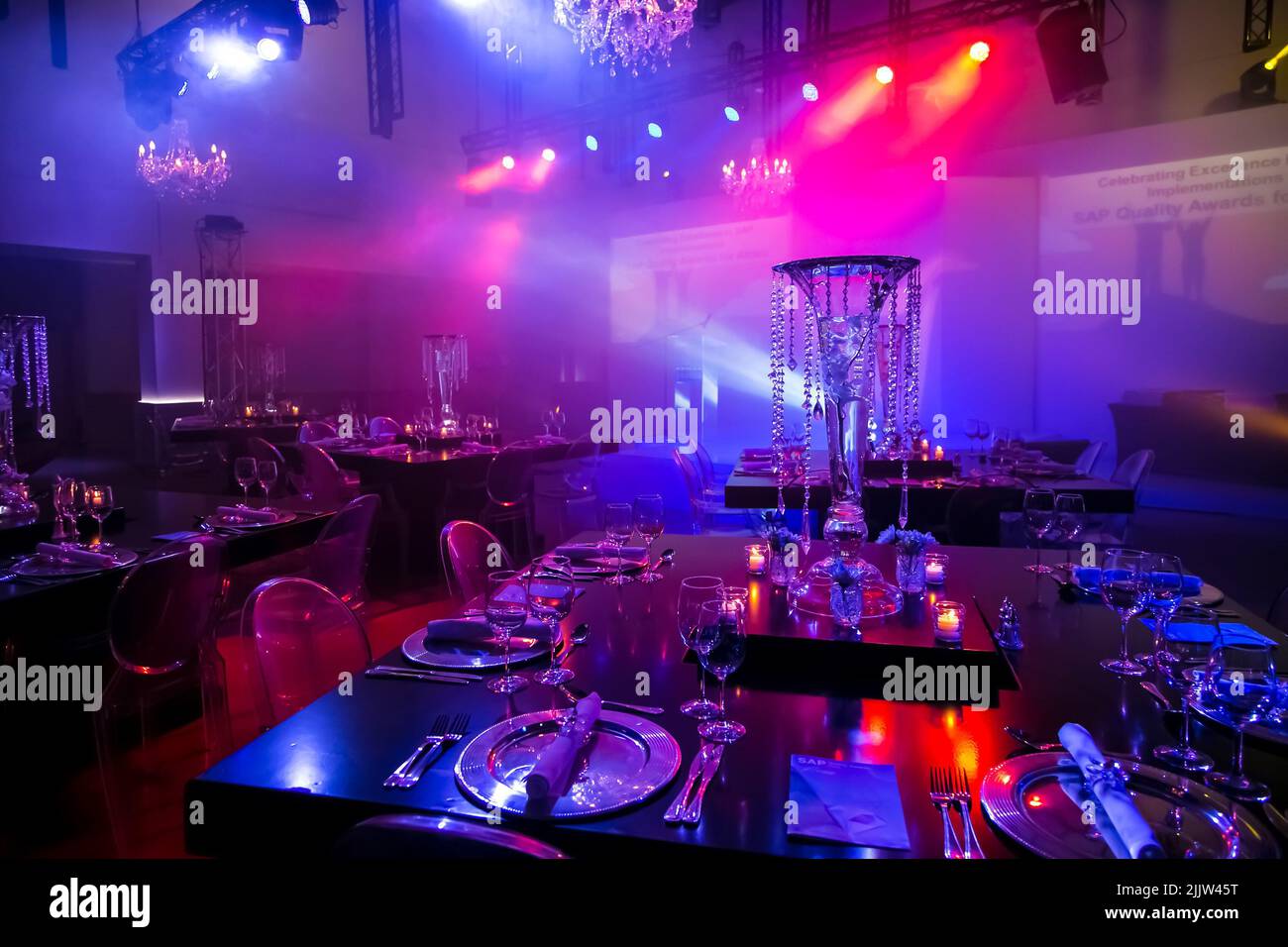 The Purple themed decor in the venue for the party event, at a large corporate gala dinner event