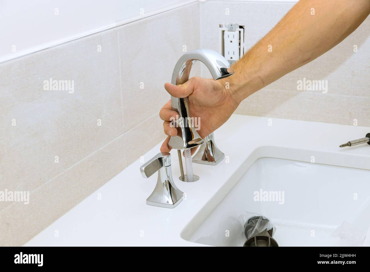 Plumber assemble and install water faucet in the bathroom Stock Photo