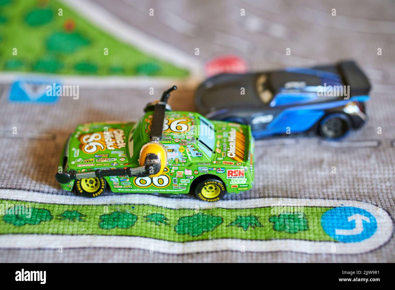 A closeup of Mattel Chick Hicks toy model car from the Disney Pixar Cars movie on a play road mat Stock Photo