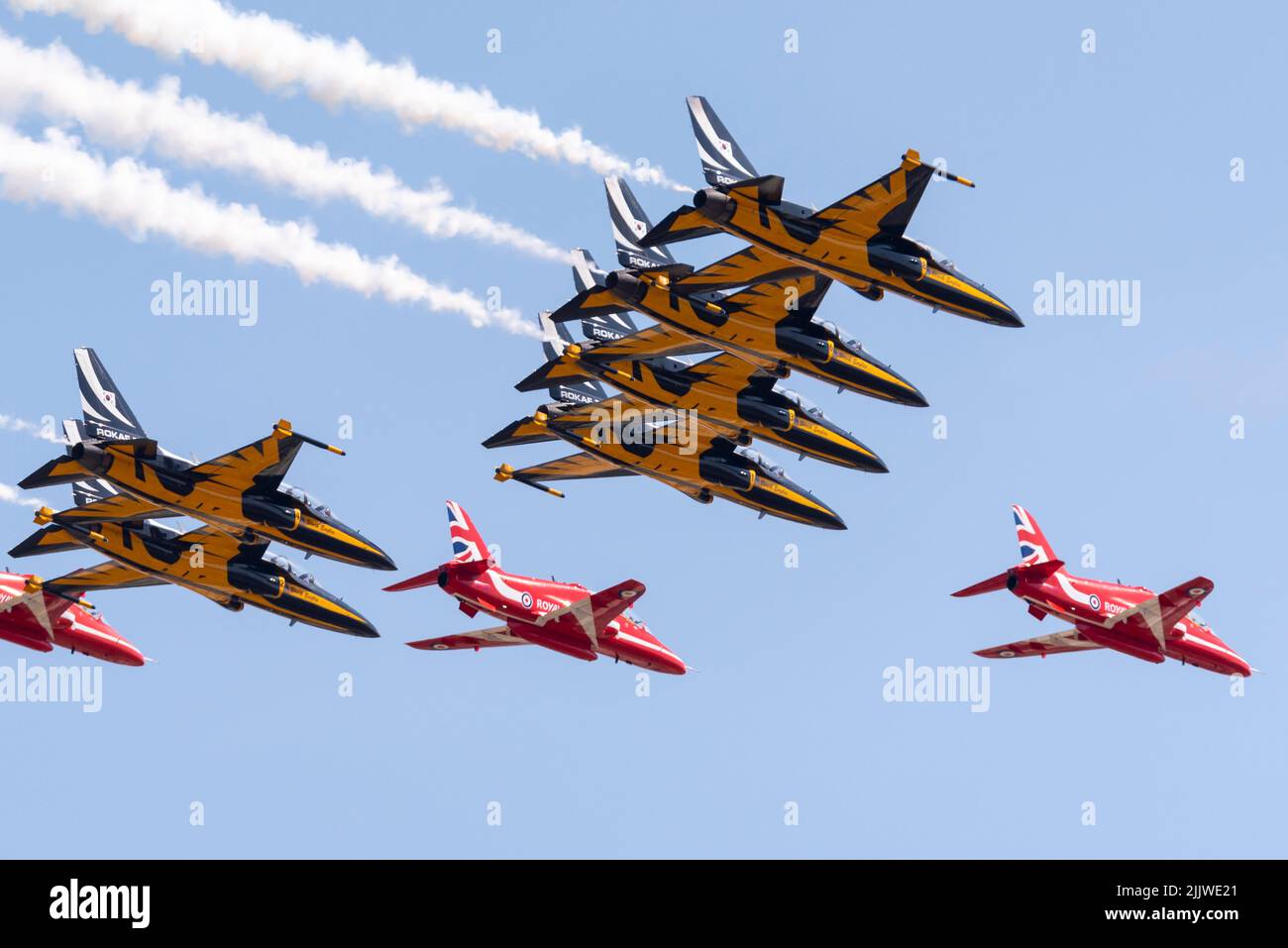 Royal Air Force Red Arrows display team flying at Royal International Air Tattoo airshow with Republic of Korea Black Eagles T-50 Golden Eagle jets Stock Photo