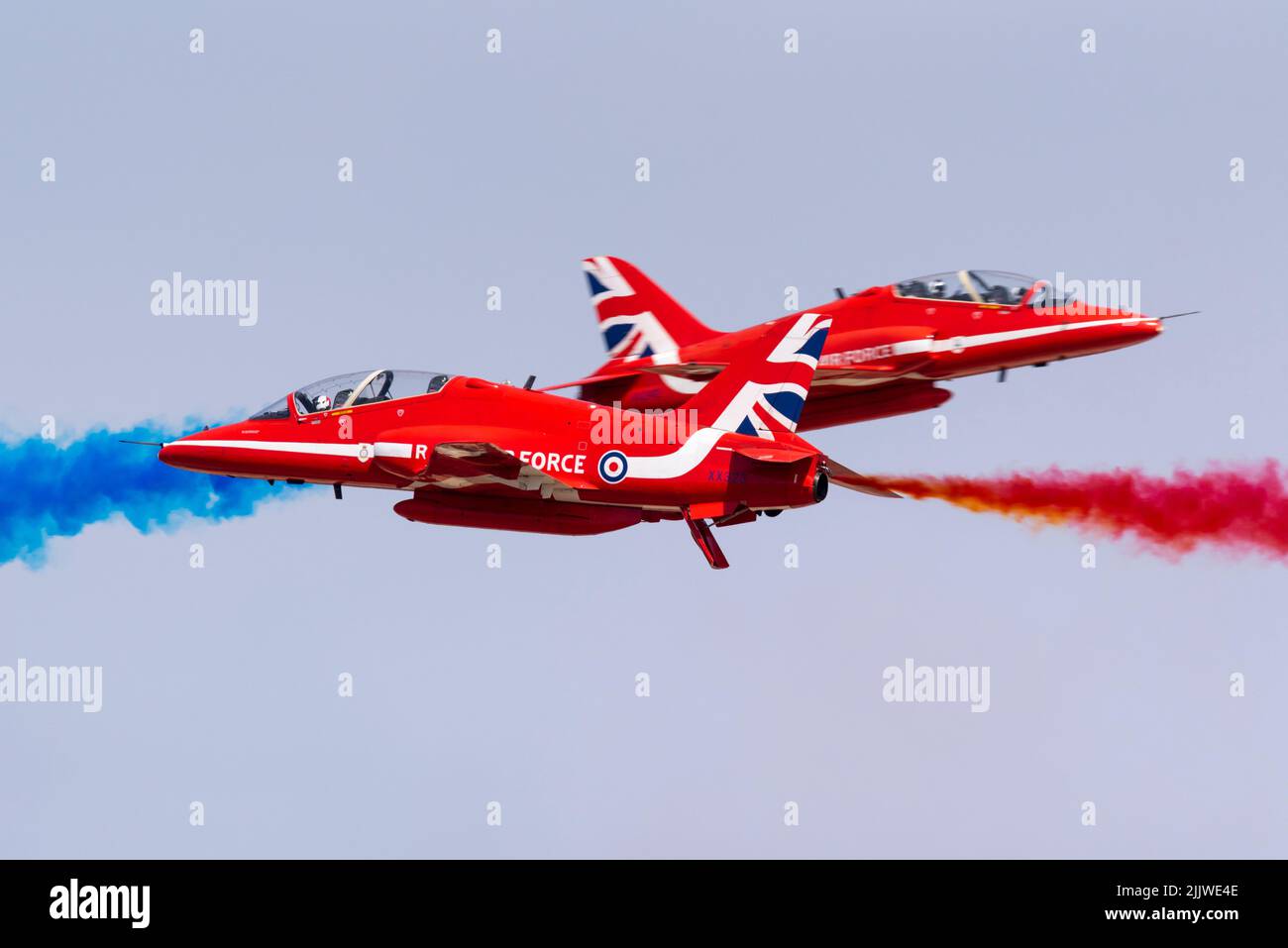 Royal Air Force Red Arrows display team flying at the Royal International Air Tattoo airshow at RAF Fairford, UK. Synchro Pair opposition pass Stock Photo