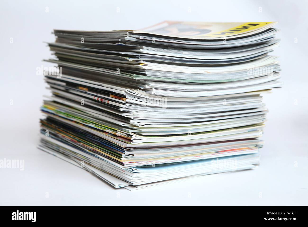 A large stack of printing magazines on a white background. Lots of different publications Stock