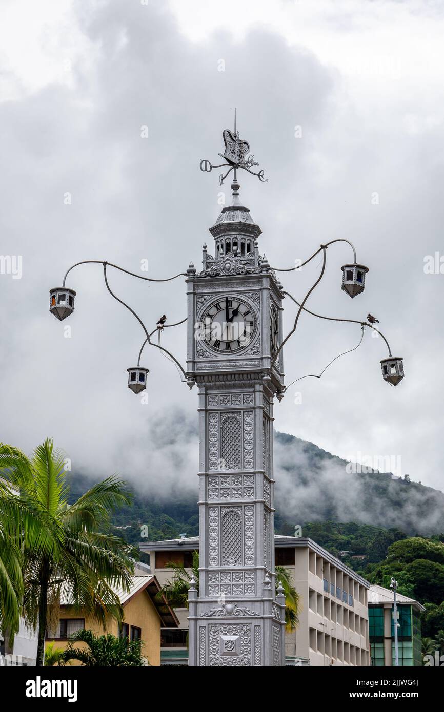 The Victoria Clock Tower, or 'mini Big Ben', copy of London's Big Ben in the city center of Victoria, Seychelles' capital, with cloudy sky. Stock Photo