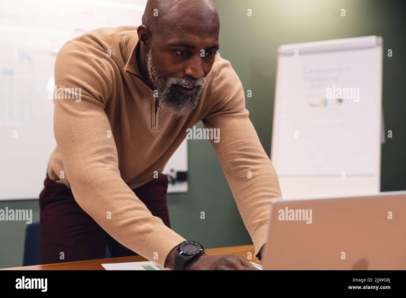 African american mature businessman using laptop in creative office Stock Photo