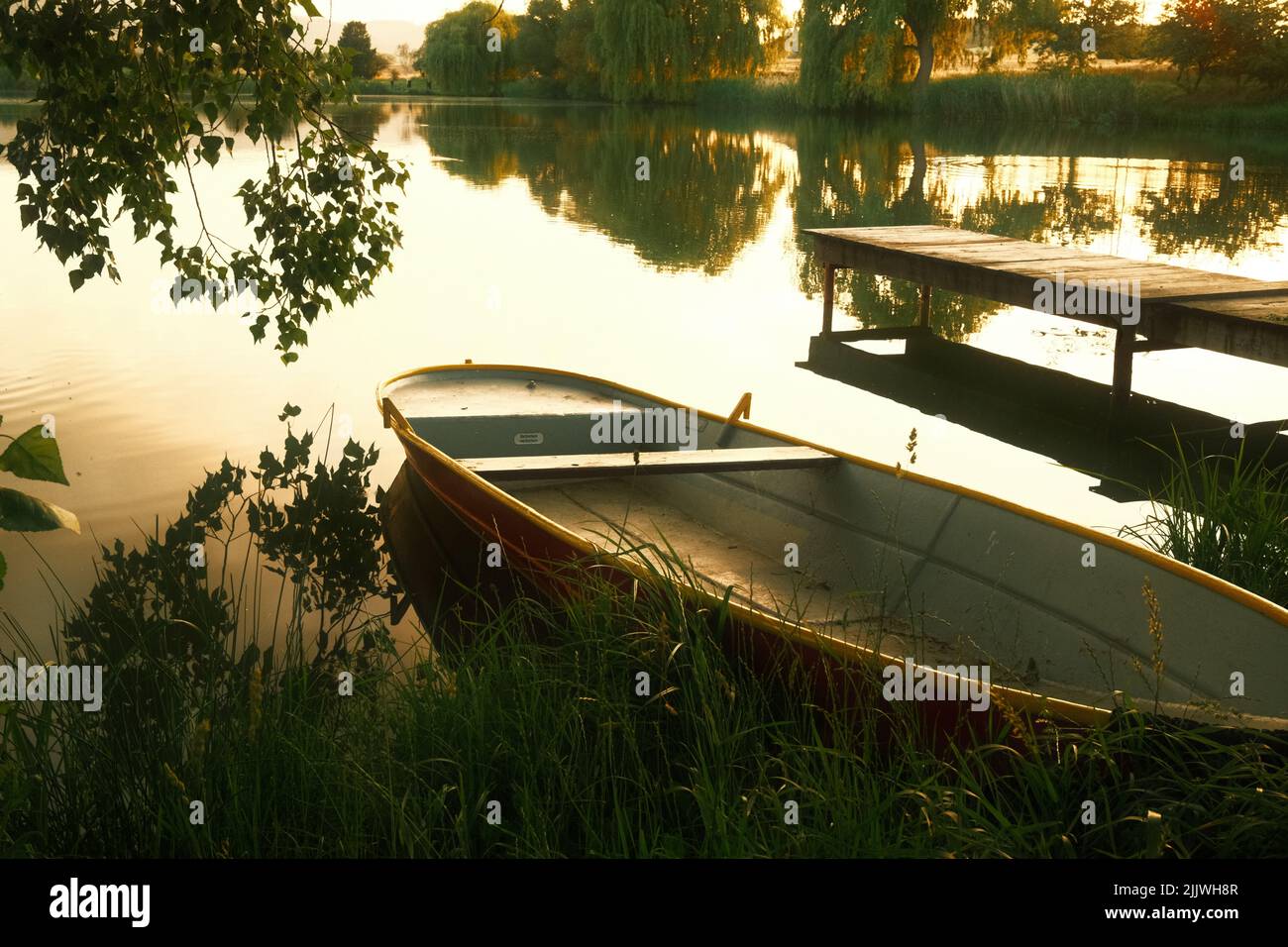 Fishing boat on the lake. sunlight in the evening Stock Photo