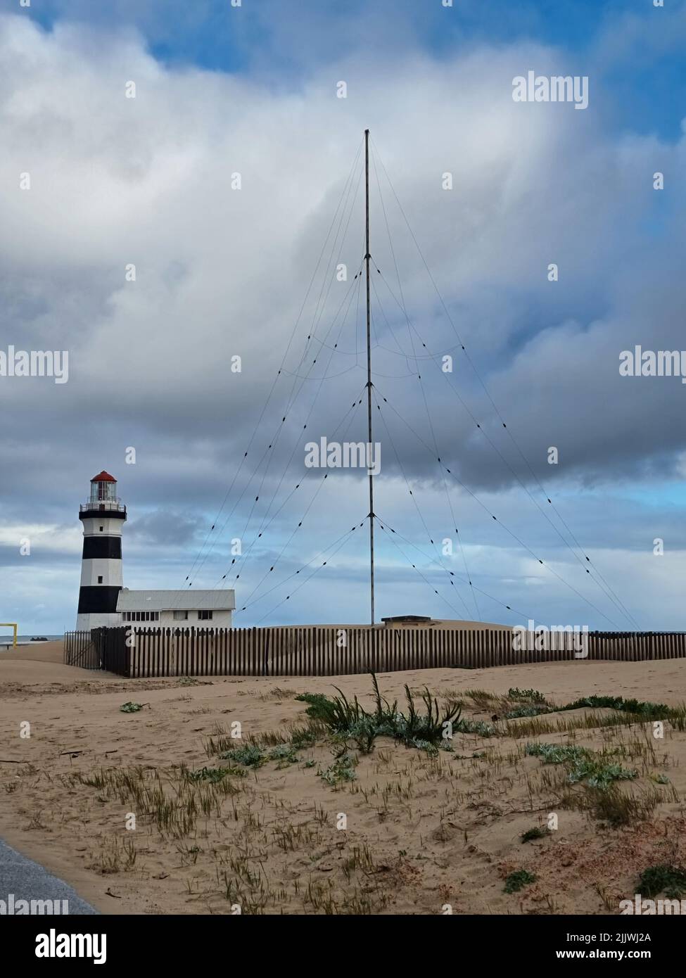 A vertical shot of the Cape Recife Lighthouse in the sands, Port ...