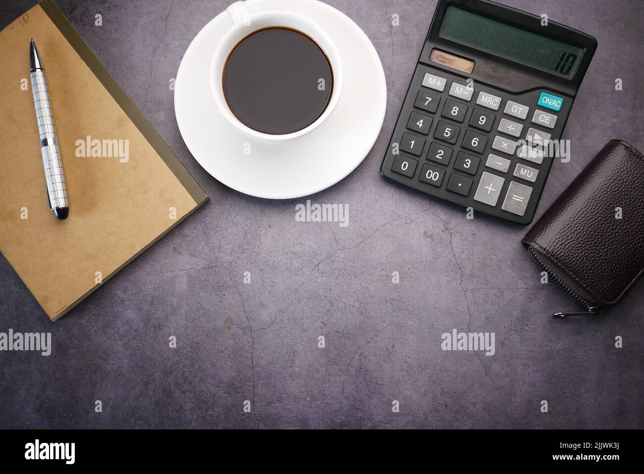 flat composition coffee, notepad and calculator on black background . Stock Photo