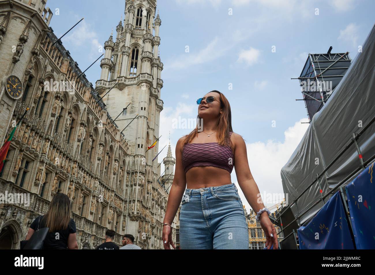 A low angle shot of a beautiful young female posing in the streets of Brussels Stock Photo