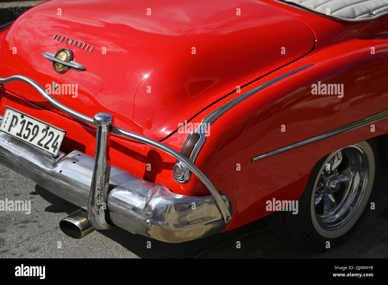 Vintage 1956 red Oldsmobile Futura with a polished chrome bumper and Cuban plates in Havana, Cuba. Stock Photo
