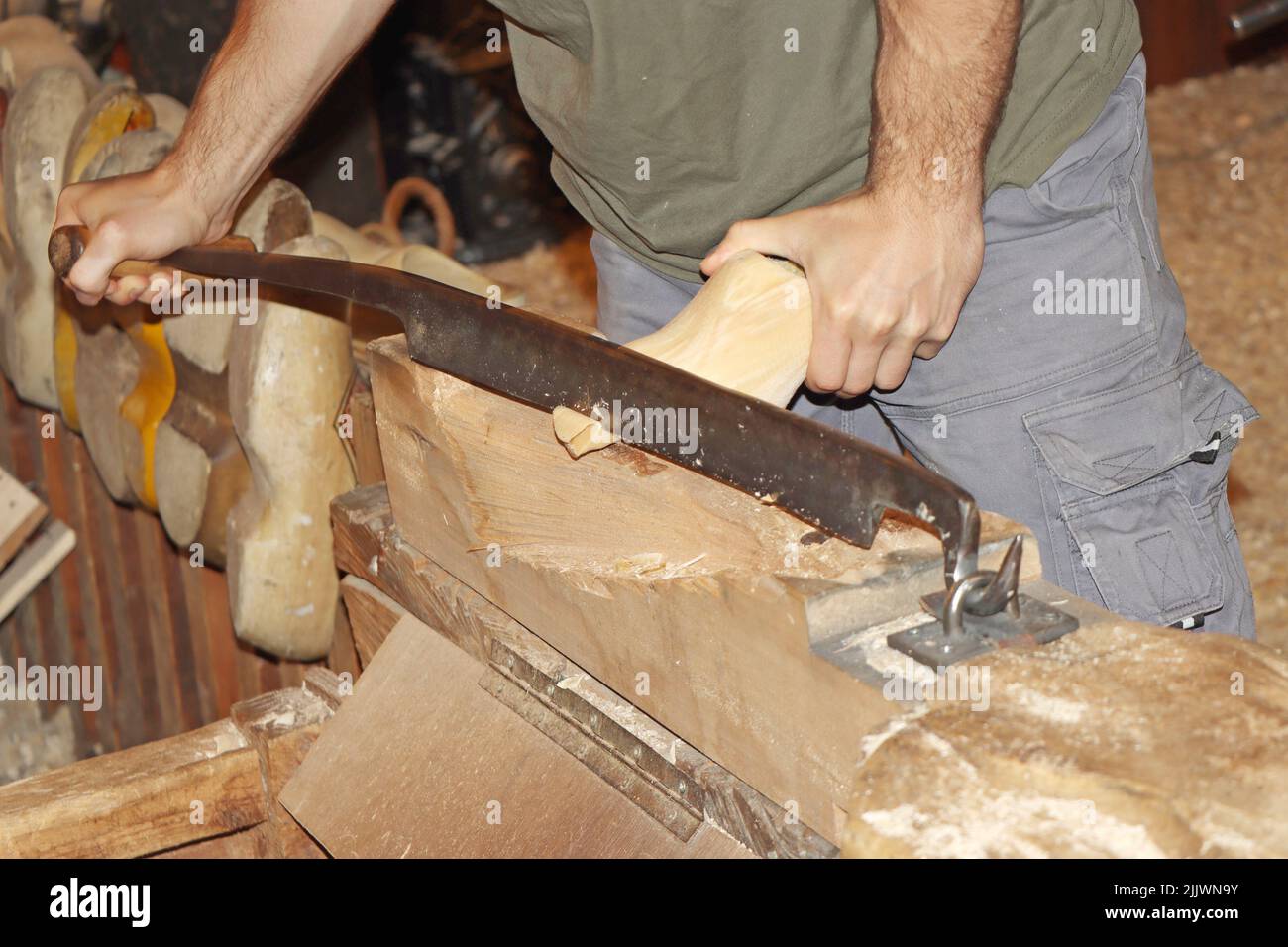 The making of clogs, a traditional Dutch craft of making wooden traditional shoes. Stock Photo