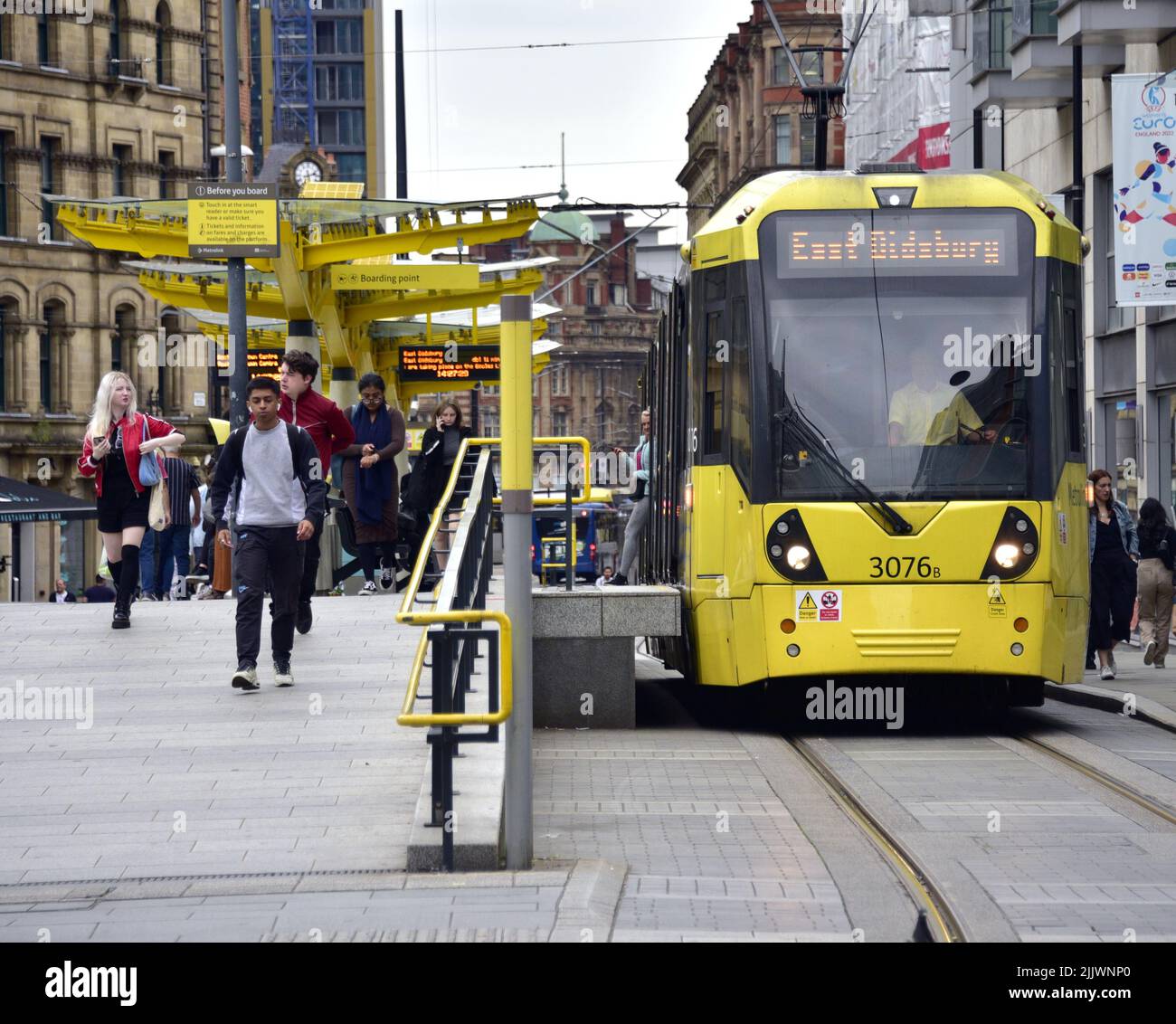 A Manchester Metrolink tram in the city centre, Manchester, Greater Manchester, England, United Kingdom, British Isles. Manchester Metrolink trams are to allow pet dogs on Greater Manchester’s trams for a three-month pilot scheme from 1 August, 2022. Currently only assistance dogs with disabled people are allowed on the trams. Stock Photo