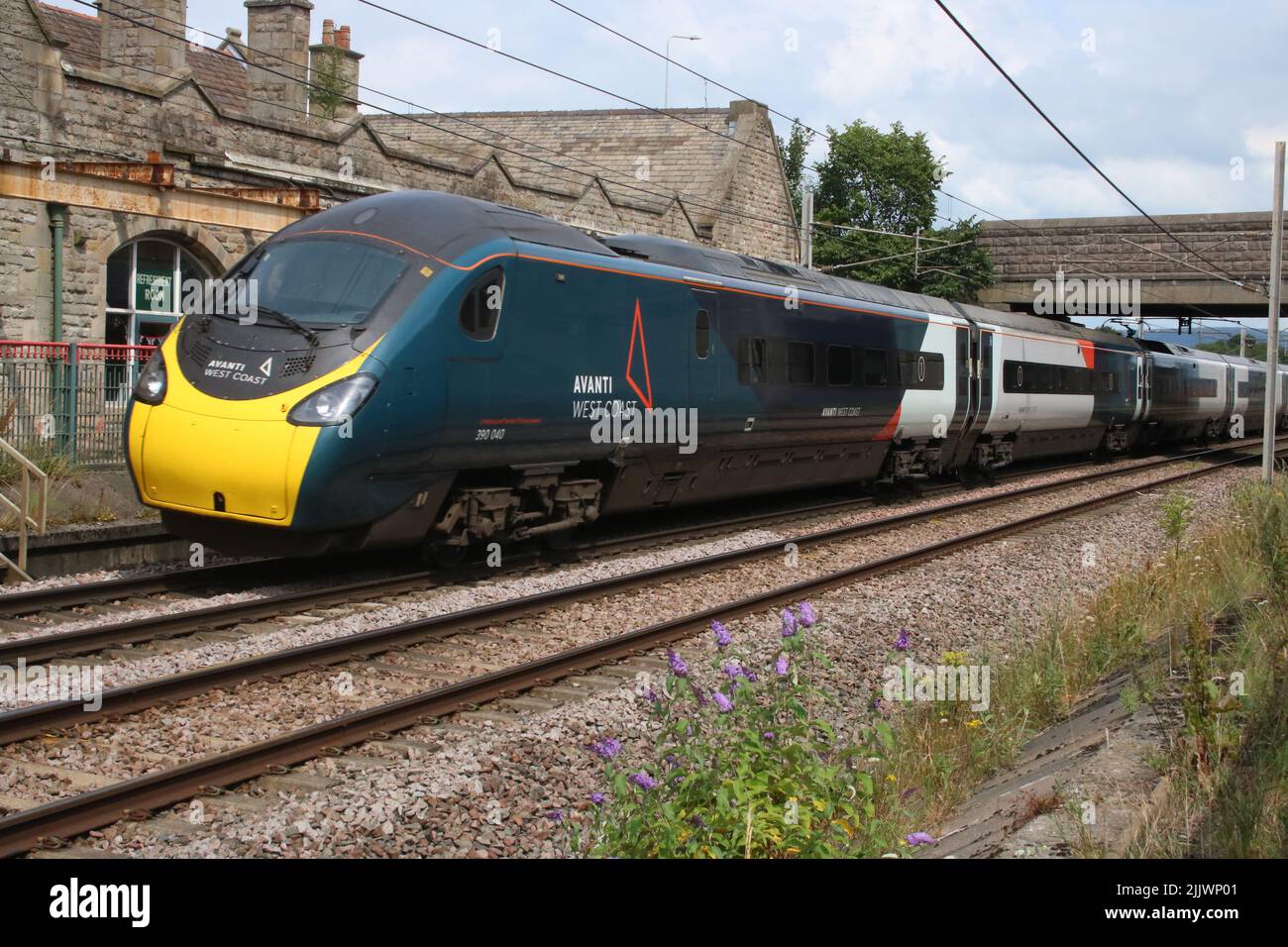 Avanti West Coast pendolino, class 390, 390040, at Carnforth on West Coast Main Line on Wednesday 27th July 2022 with London to Glasgow train. Stock Photo