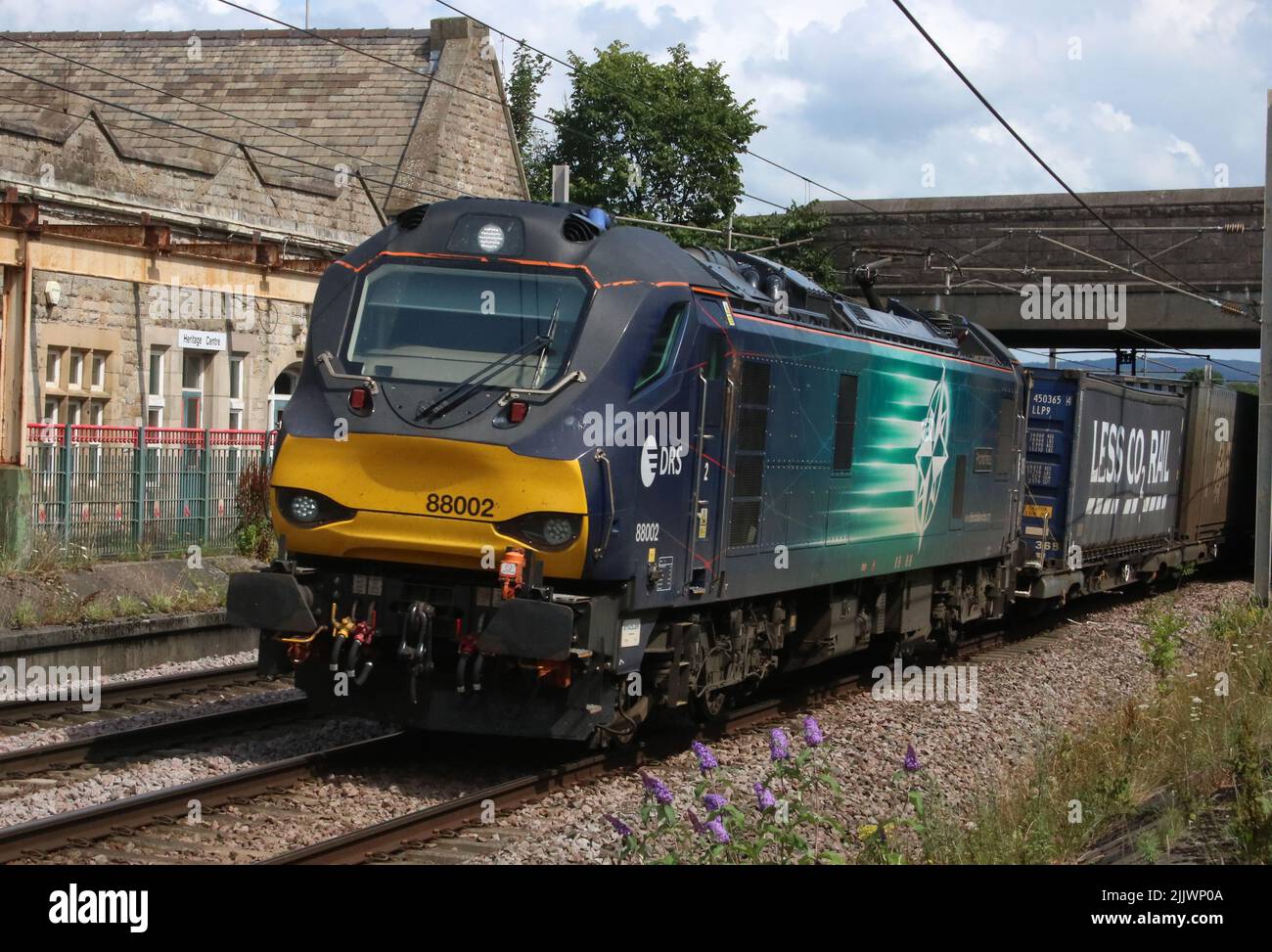 Direct Rail Services class 88 electro-diesel, 88002 Prometheus, passing Carnforth on West Coast Main Line with container train on 27th July 2022. Stock Photo