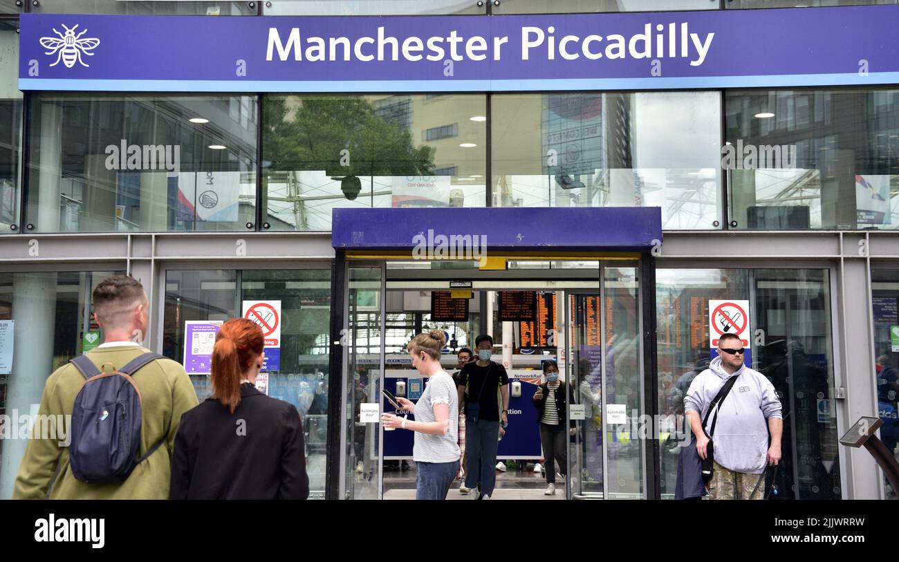 Travellers or passengers at an entrance to Piccadilly Rail station, Manchester, England, United Kingdom, British Isles. Trade union Aslef said today that train drivers at nine rail companies will strike for another 24 hours on August 13th, 2022, over pay. Aslef says the firms failed to make a pay offer to help members keep pace with increases in the cost of living. Stock Photo