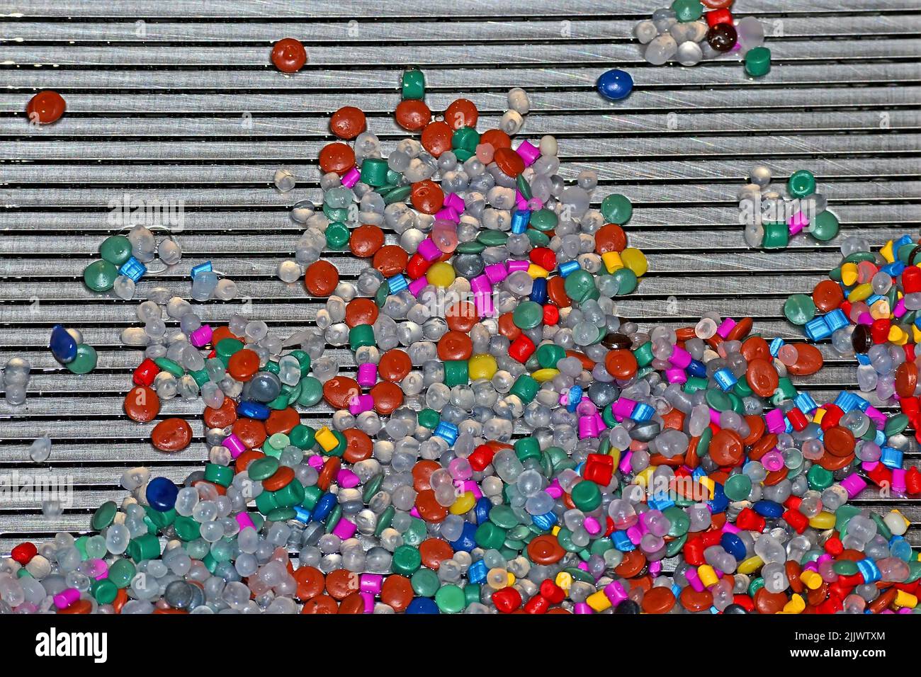 abstract random color components heap on metal silver grid, industrial ...