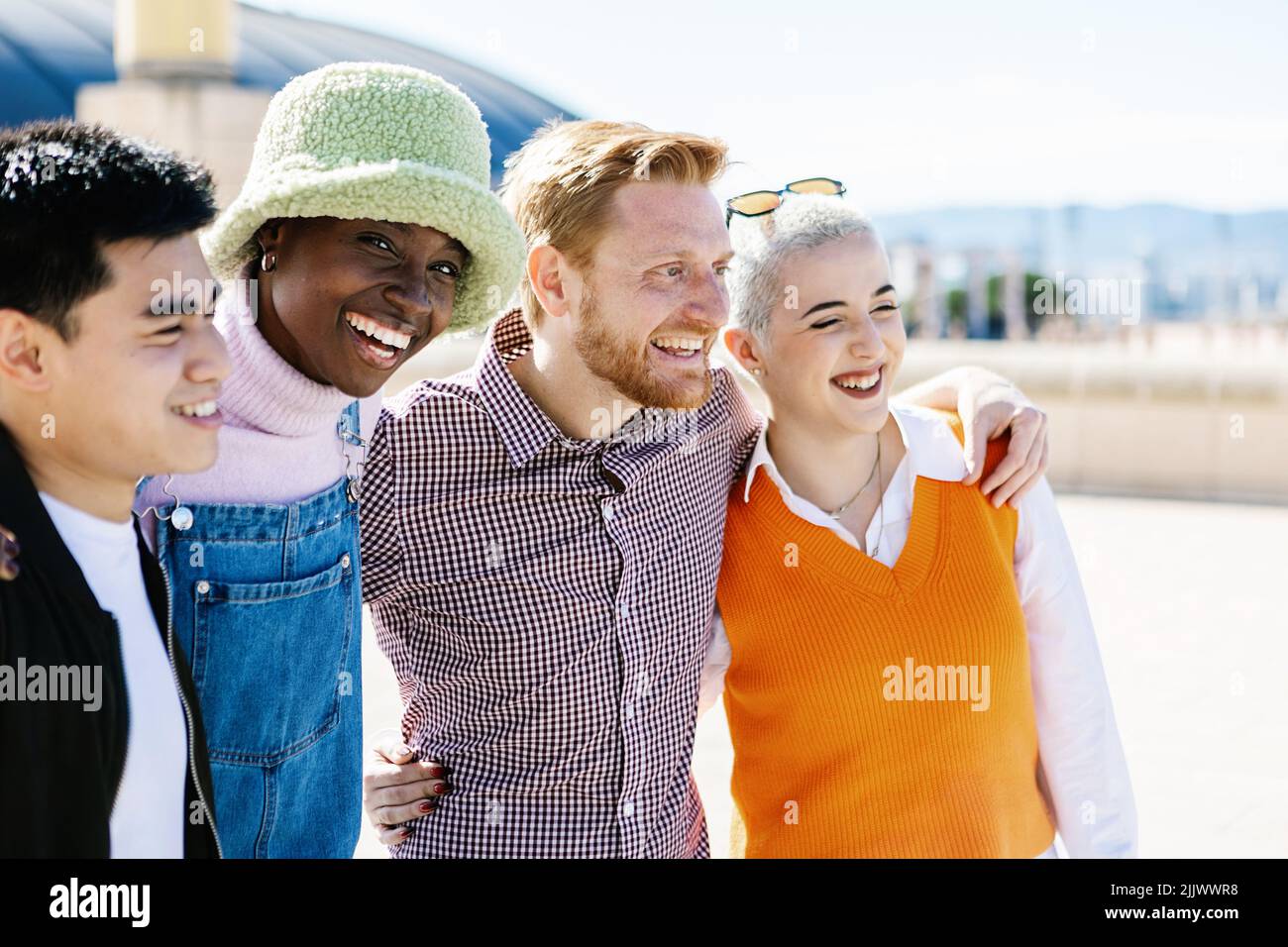 Multiracial group of young people hugging and embracing together outdoor Stock Photo