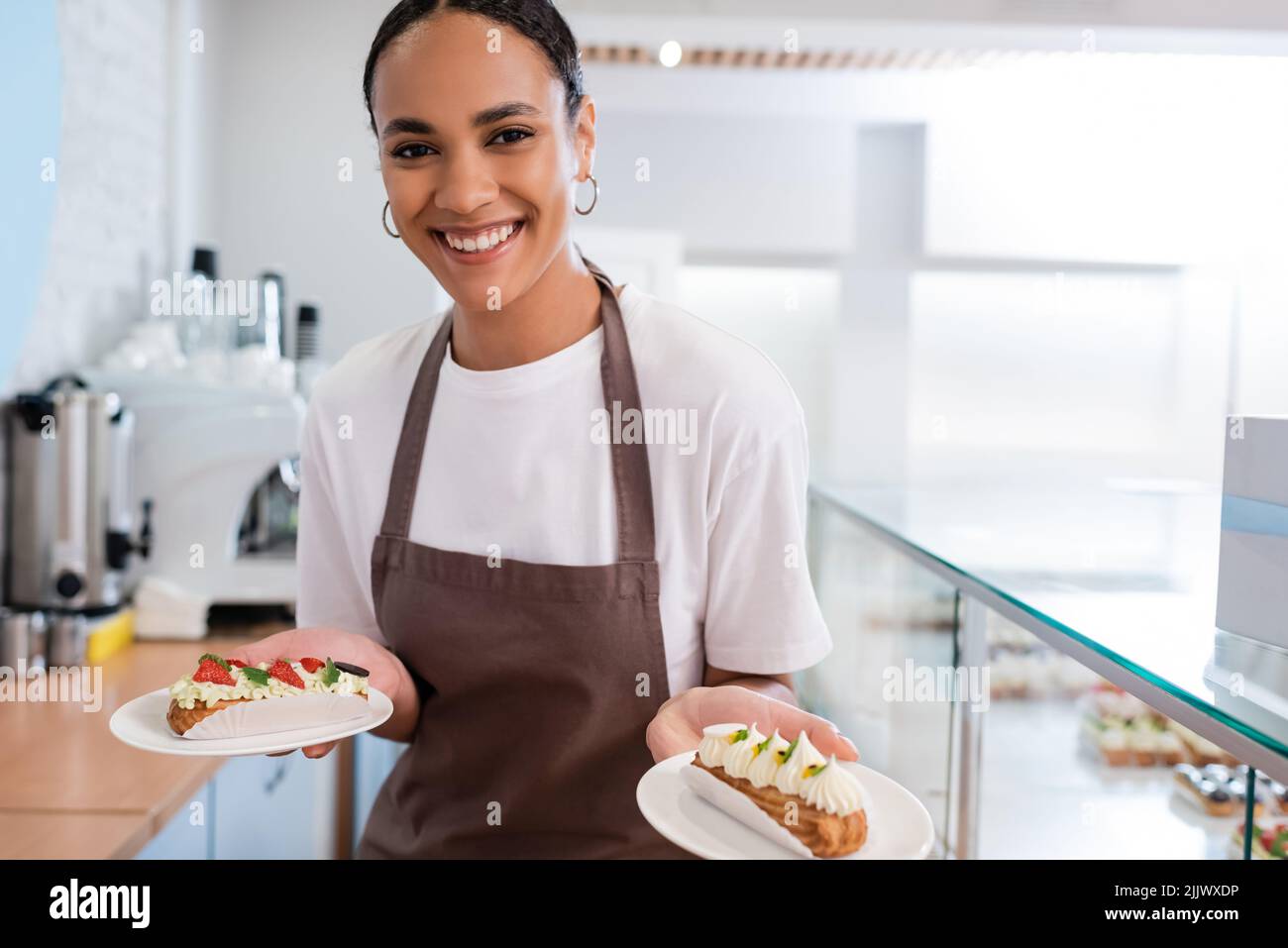 Cheerful worker in black apron hi-res stock photography and images - Alamy
