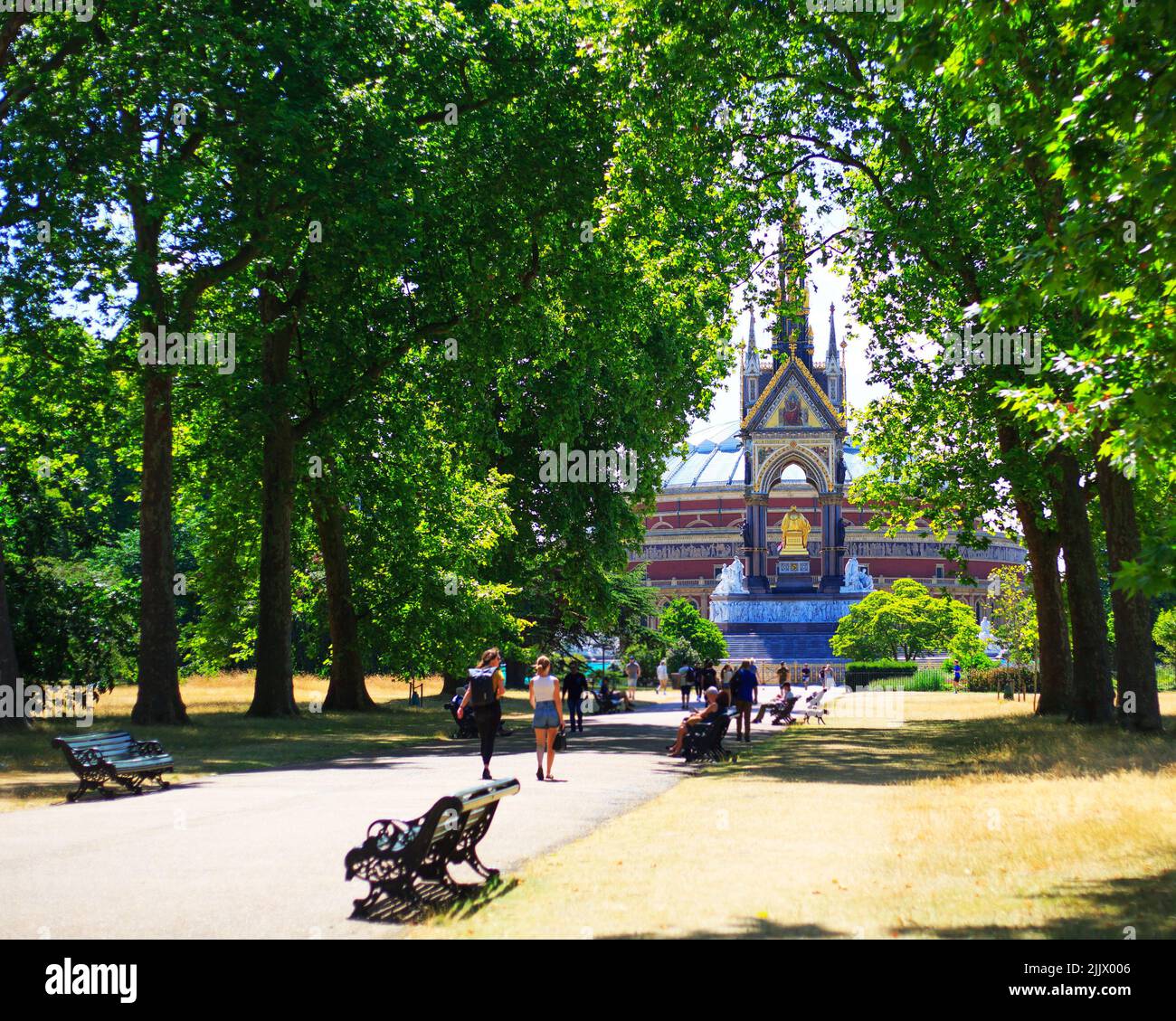 Scenic view looking down the path towards the rear of Albert Memorial, with the Albert Hall in the background on a bright summer day, framed by trees Stock Photo