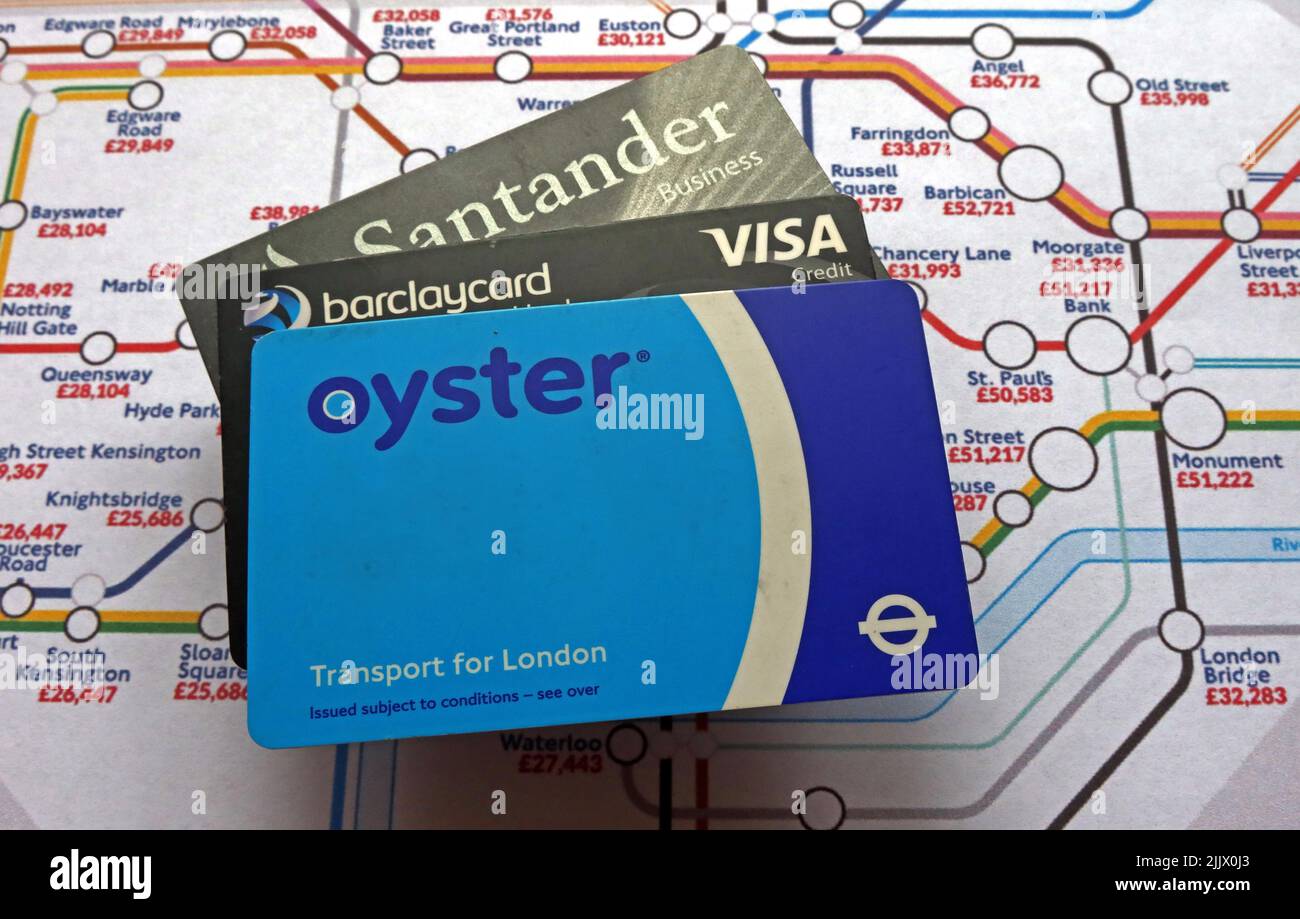 Contact, less, contactless credit cards and London Underground Oyster card and tube map with average annual income salary Stock Photo