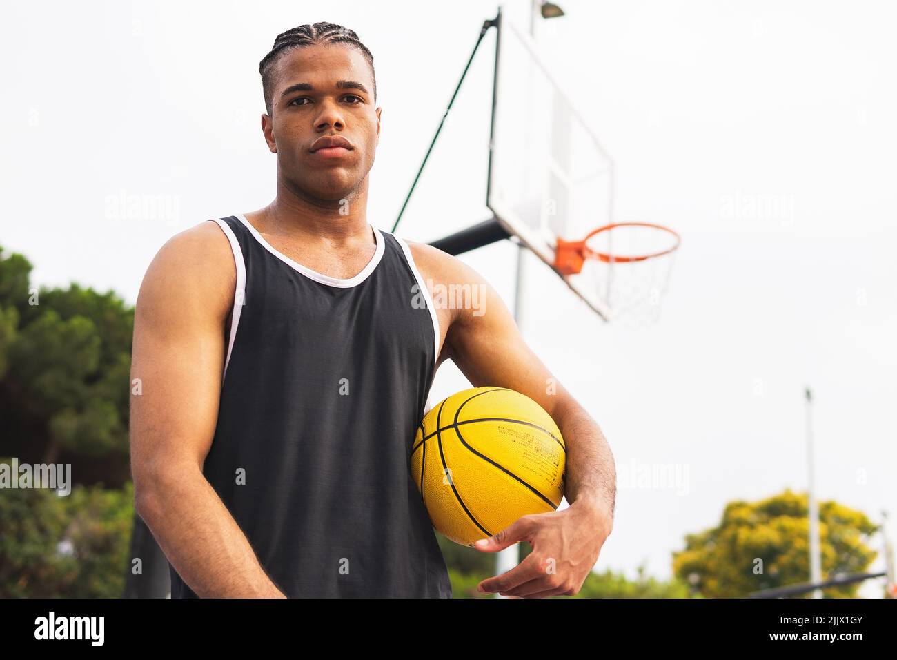 Low angle of Hispanic sportsman looking at camera before throwing ball