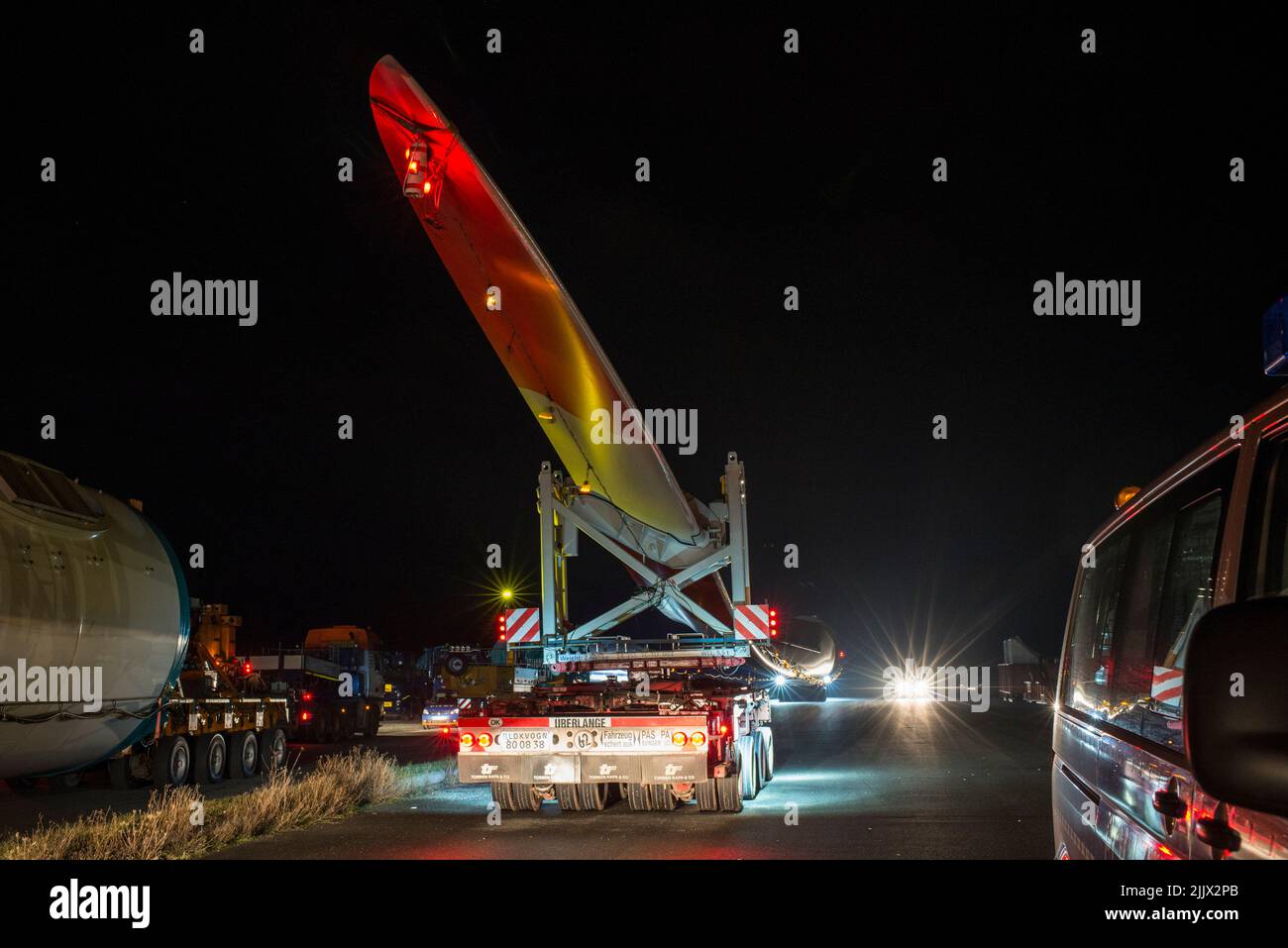 GERMANY, special transport of rotor blade SENVION 75,4m at night with heavy truck of company Torben Rafn Stock Photo