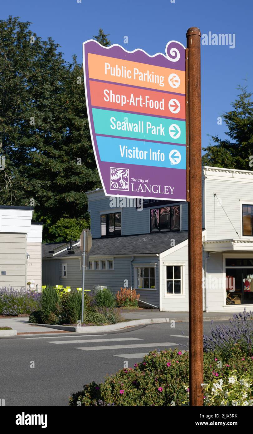 Langley, WA, USA - July 26, 2022; Sign post in Langley Washington with information on tourist directions Stock Photo