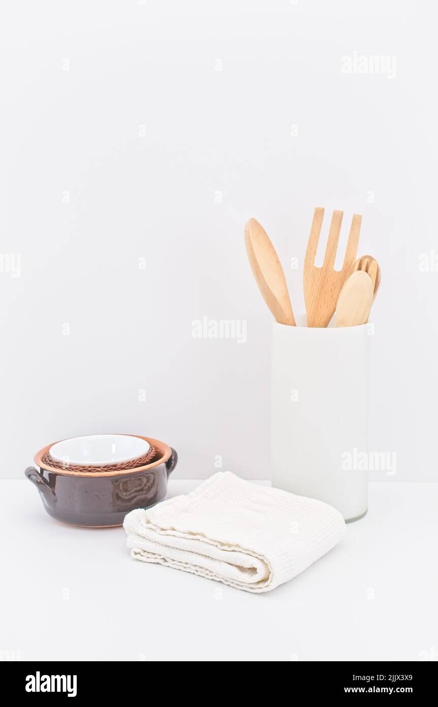 kitchenware and earthenware on a white desk against white wall Stock Photo