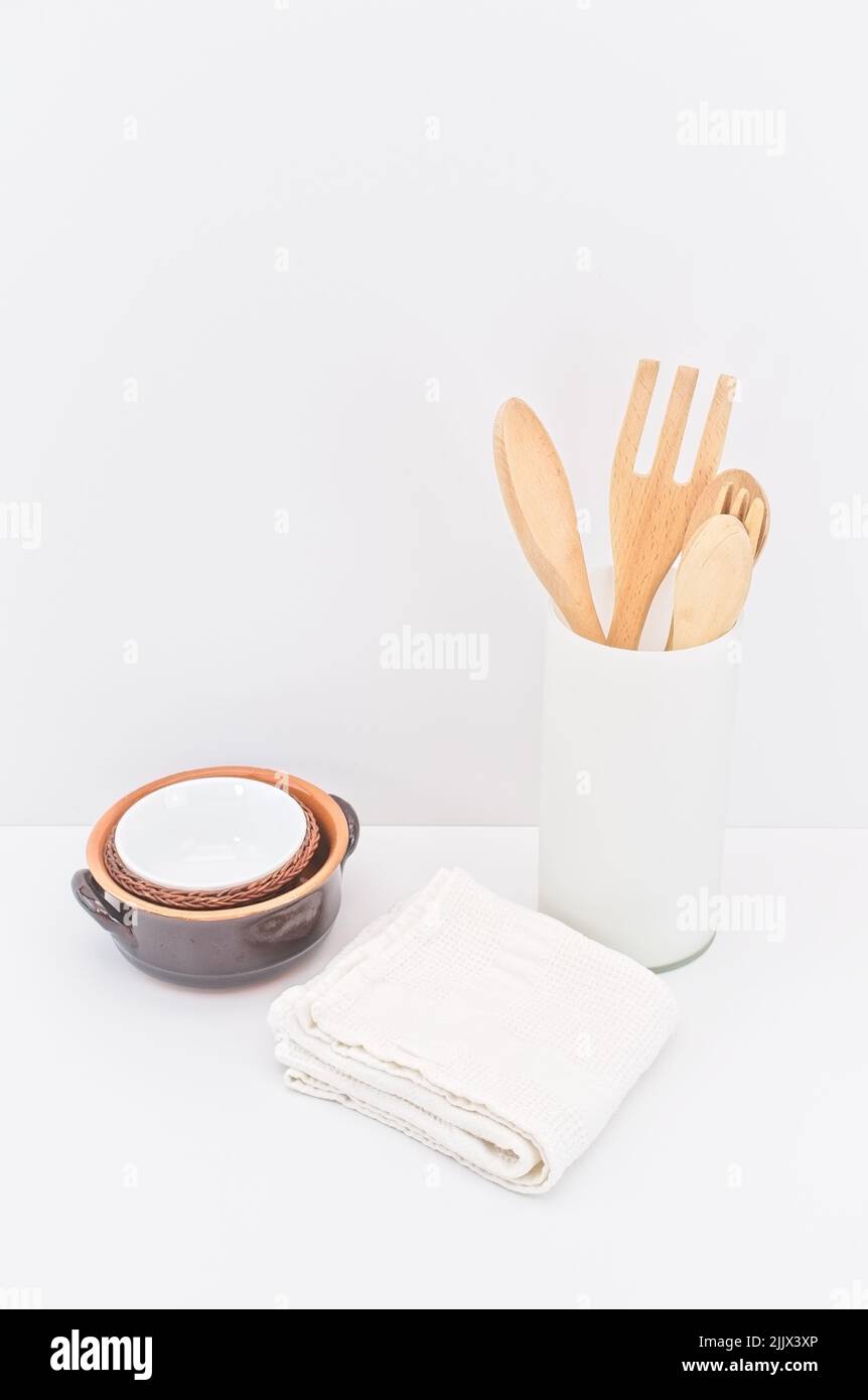 kitchenware and earthenware on a white desk against white wall Stock Photo