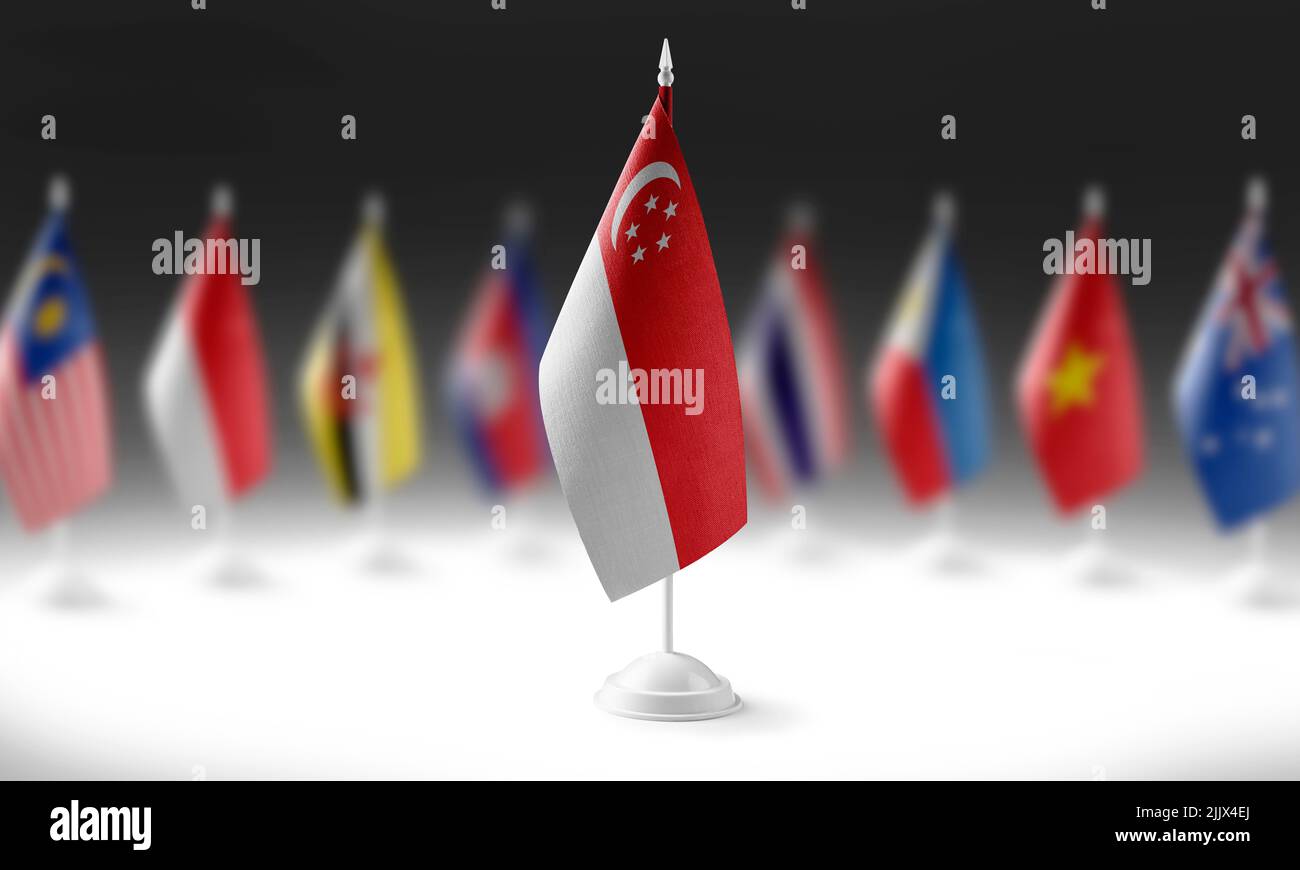 The national flag of the Singapore on the background of flags of other