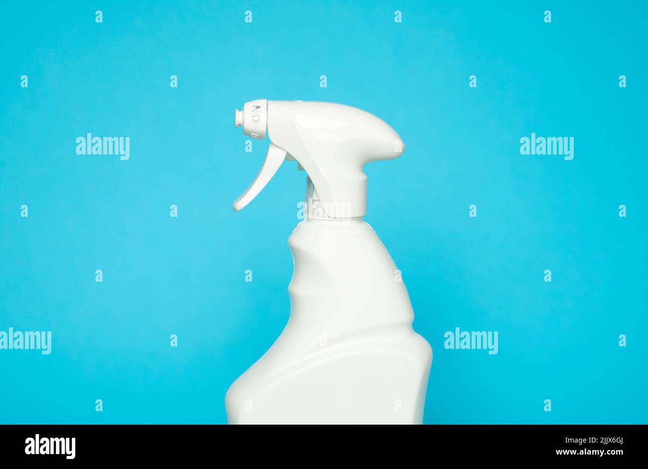 White blank plastic spray detergent bottle isolated on blue background. Packaging template mockup. Stock Photo