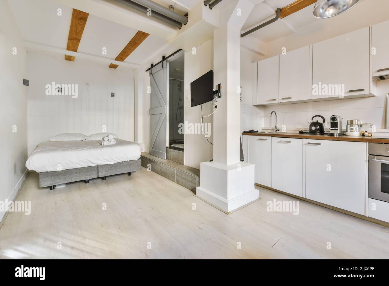 Interior of modern home with bed next to a kitchen Stock Photo - Alamy