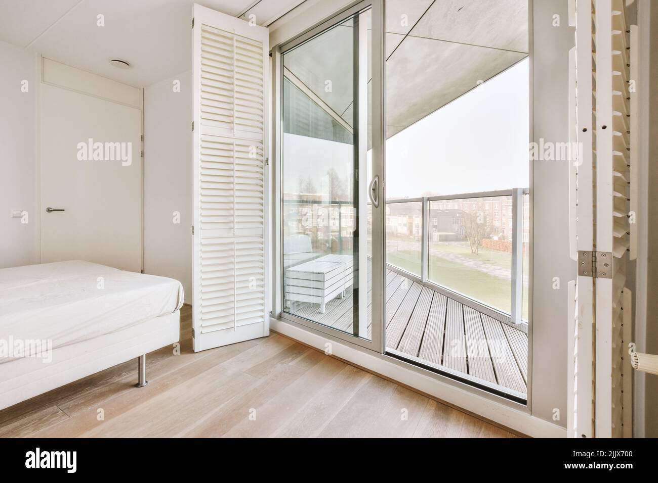 Visual Reference: Comfortable Bed In Empty Refurbished Light Bedroom With Glass Doors