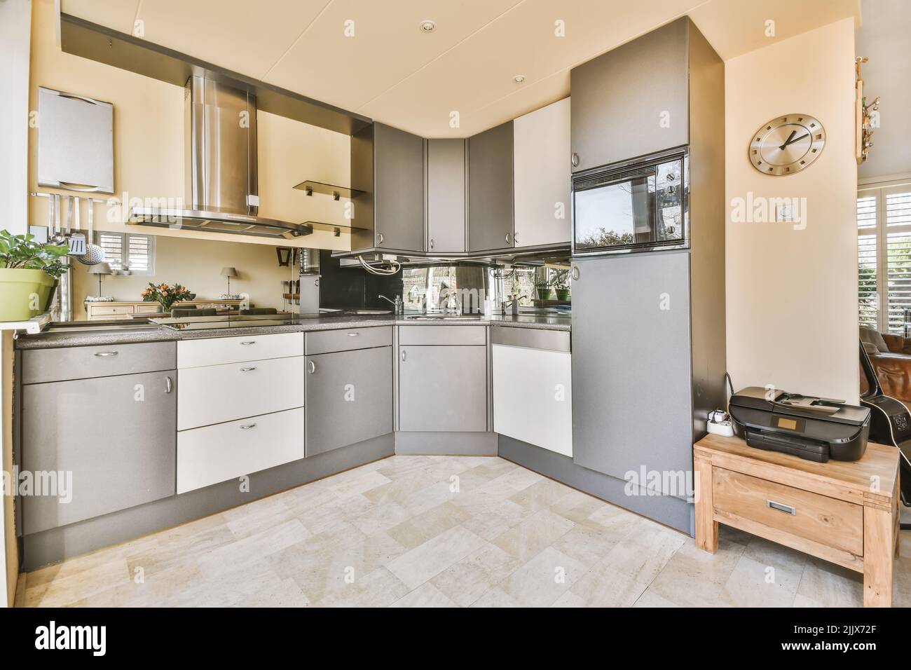 Chrome built in stove and oven in old fashion kitchen with grey