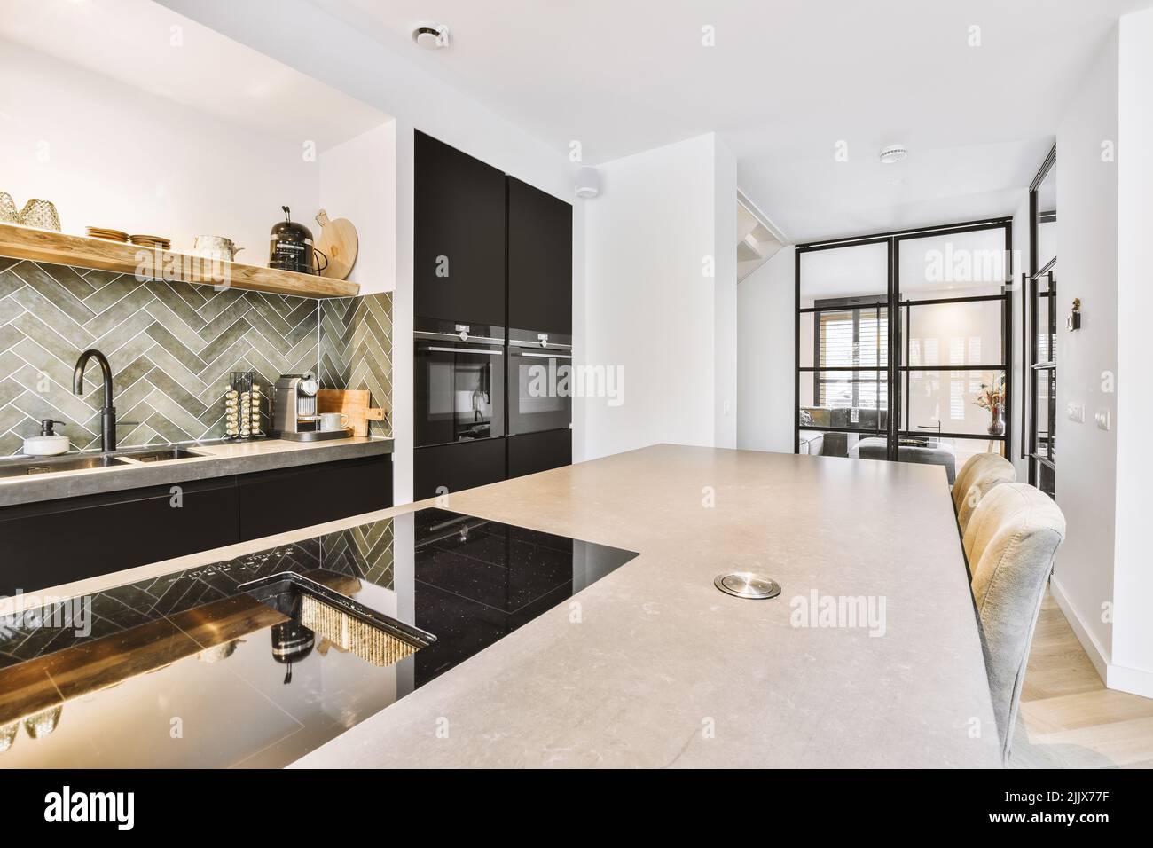 Counter with black cupboards and modern built in appliances placed in ...