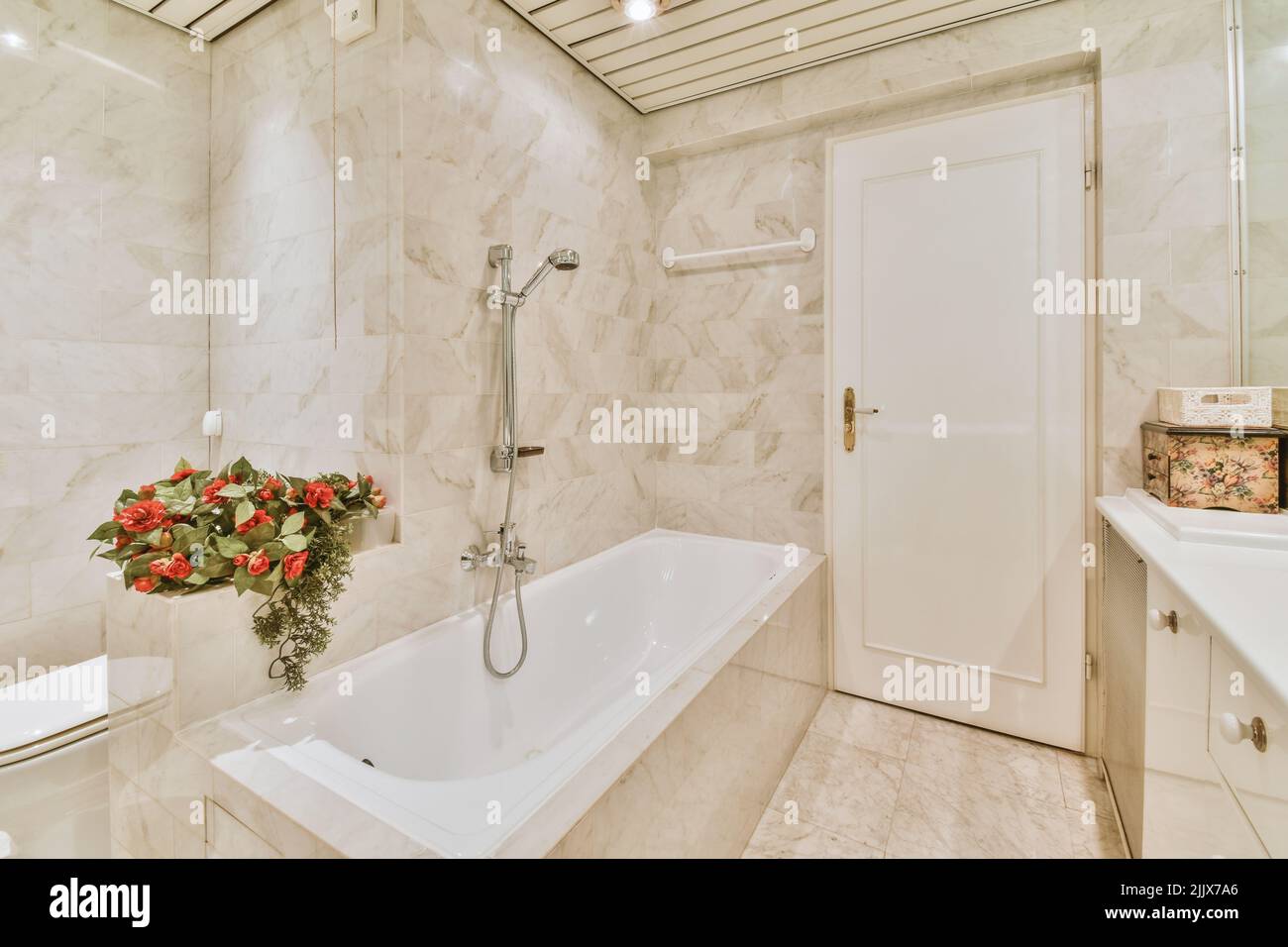 Interior of a sink with mirror next to a bathtub and white walls Stock
