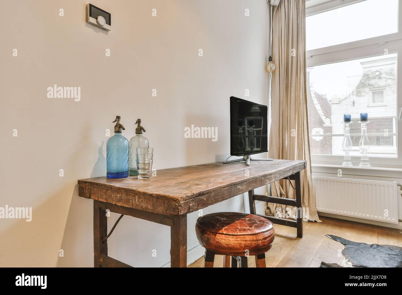 Interior of empty room with whitewash walls and laminated floor and