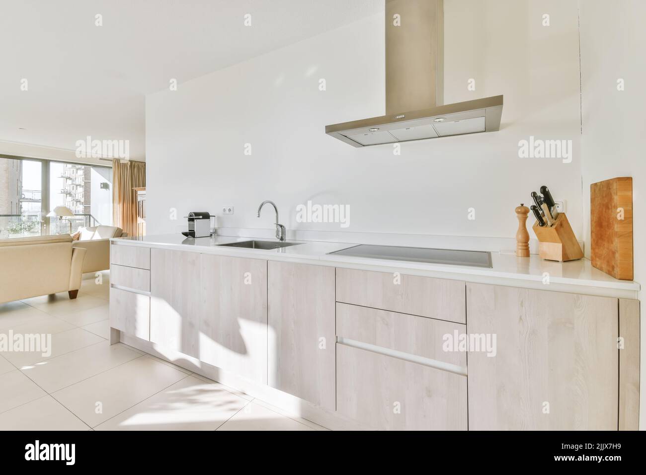 Counter with white cupboards and modern built in appliances placed in ...