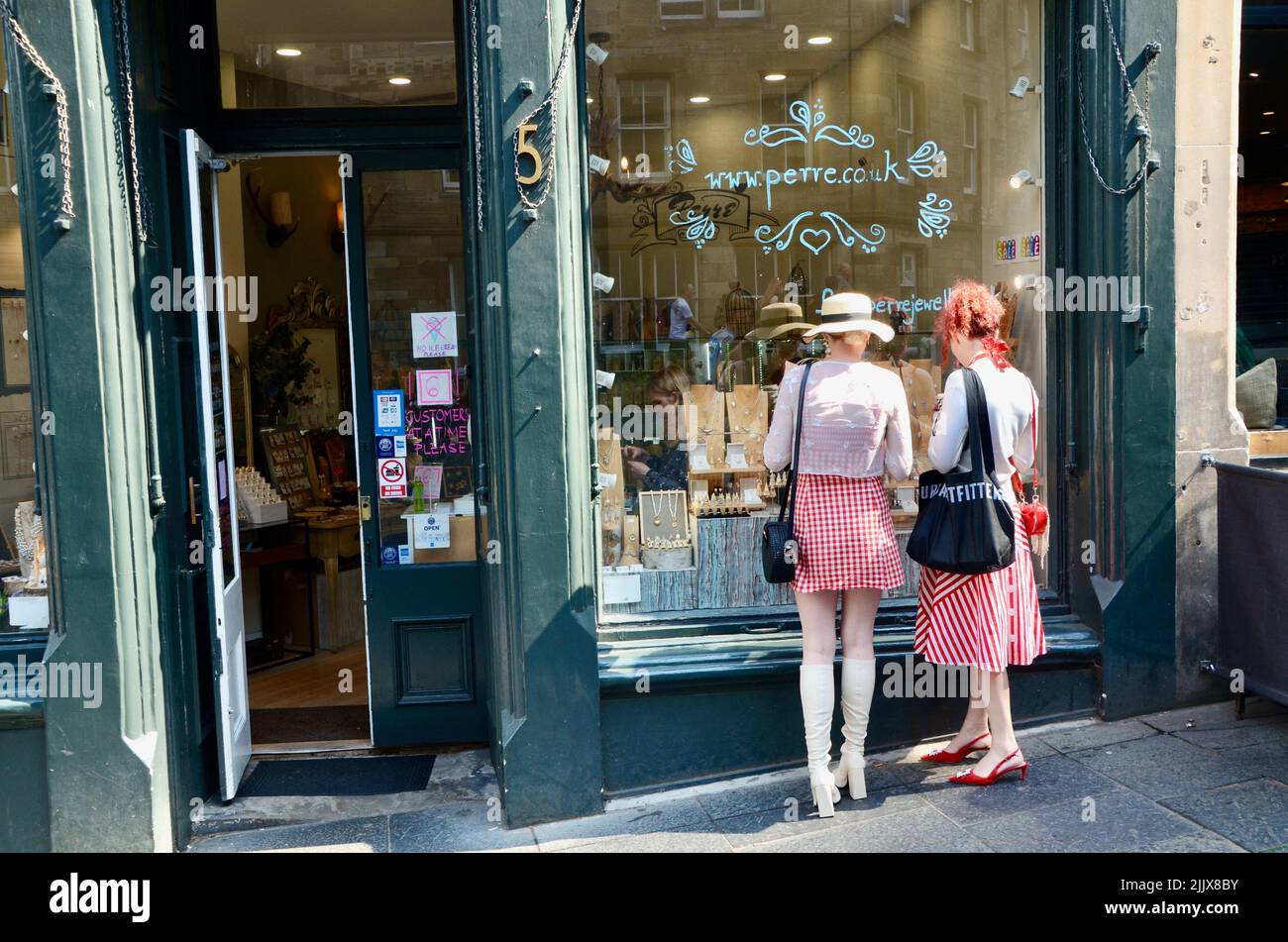 two fashionable trendy women looking into the edinburgh perre jewellery