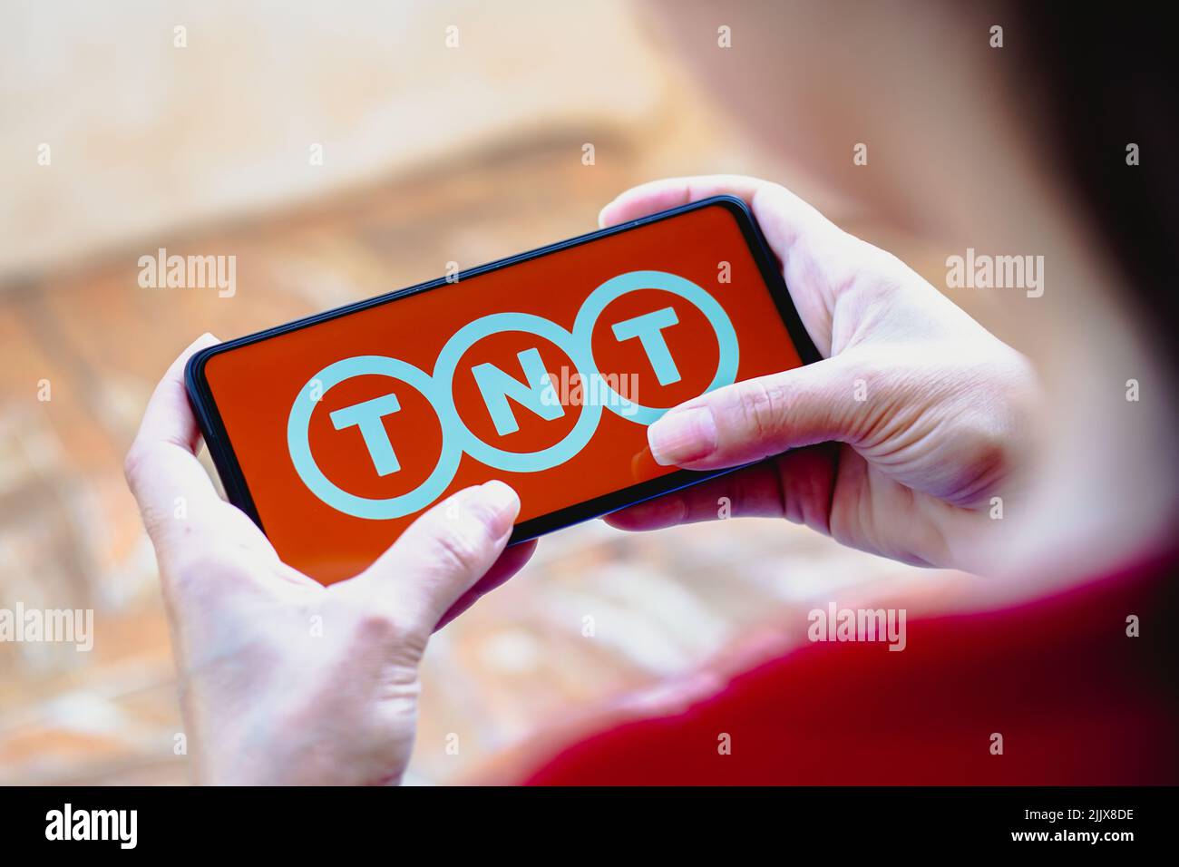 In this photo illustration, the TNT Express N.V. logo is displayed on a smartphone screen. Stock Photo